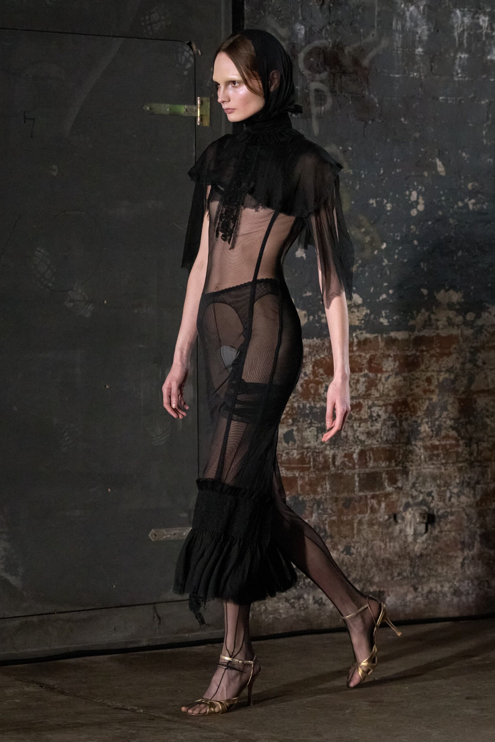 black sheer fringed gown with gold shoes