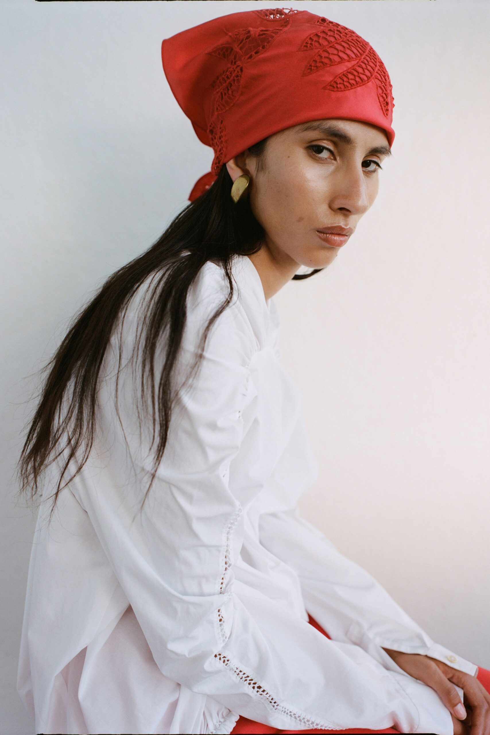white relaxed blouse with red hat