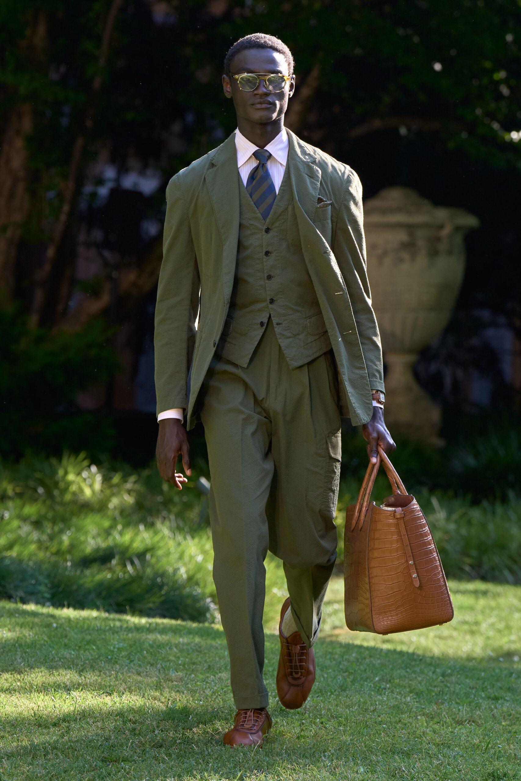 green tailored suit with brown accessories