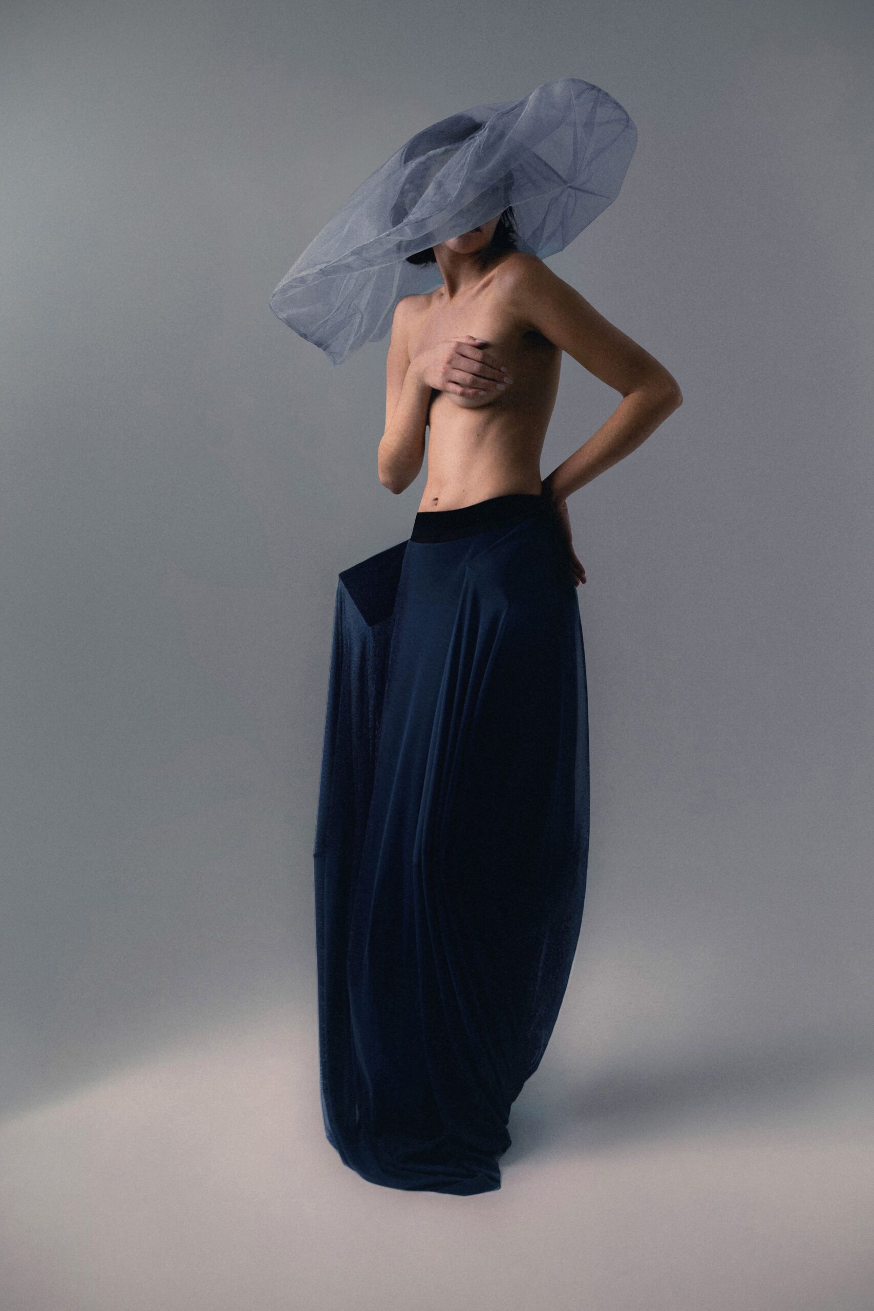 navy silk fitted gown with tulle hat