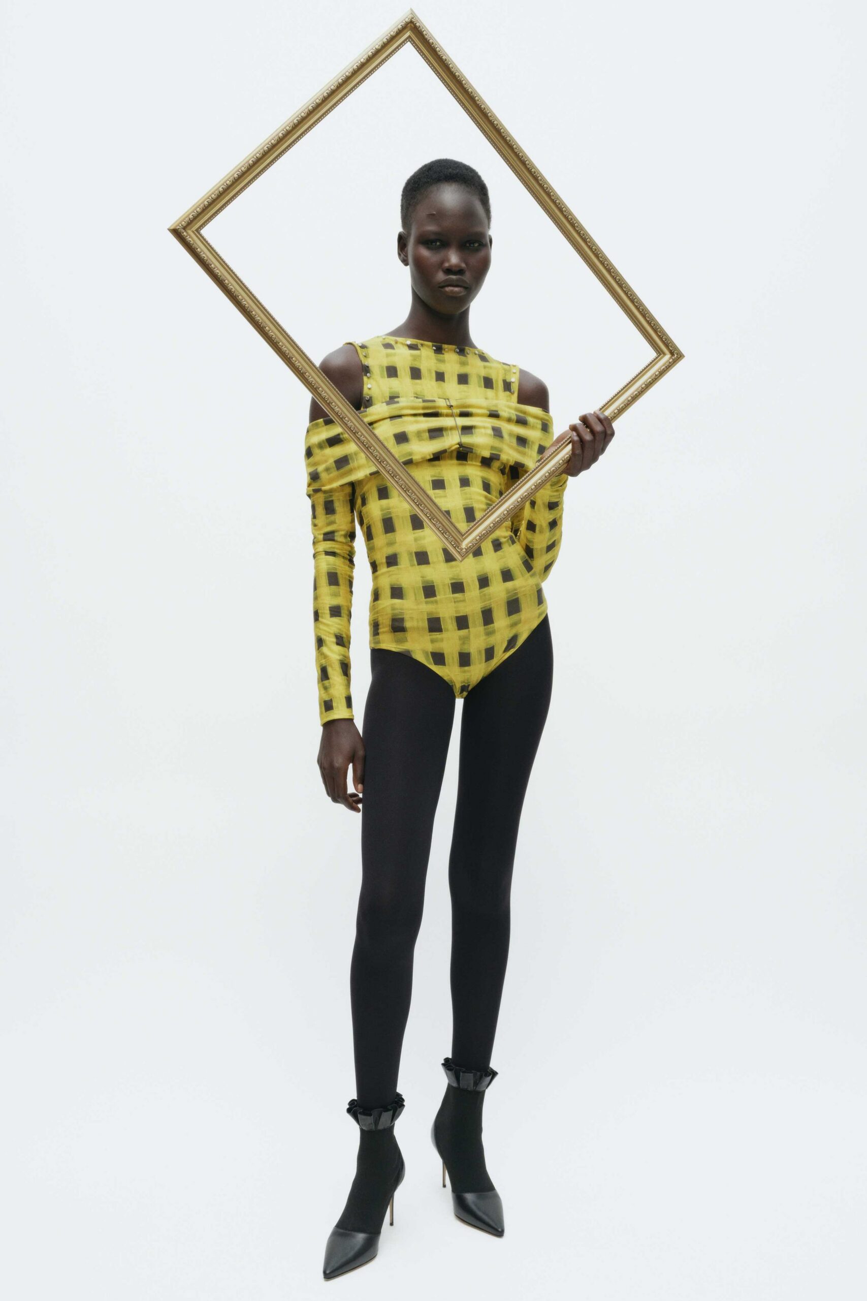 yellow checked bodysuit with black leggings