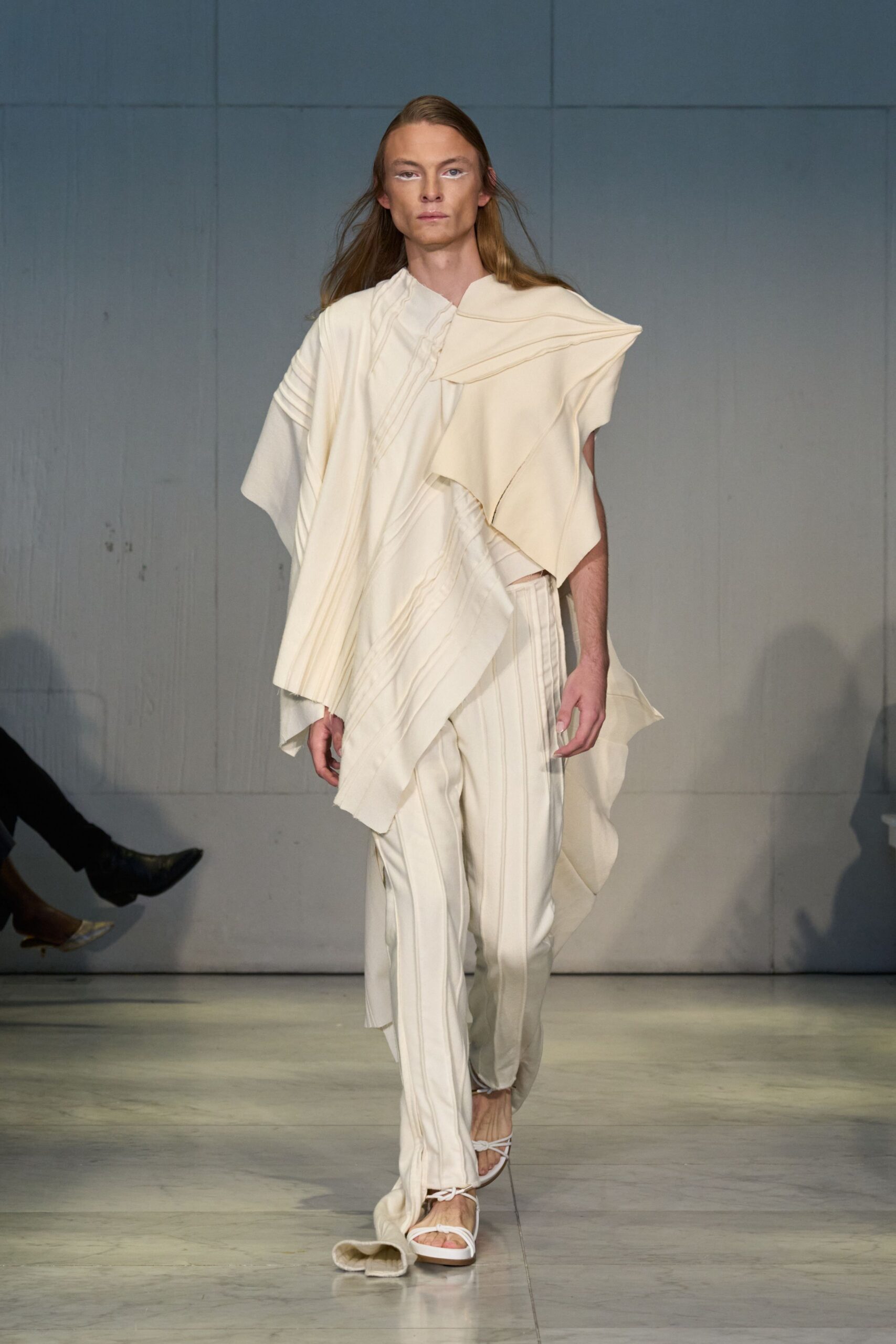 white draped top with beige pants