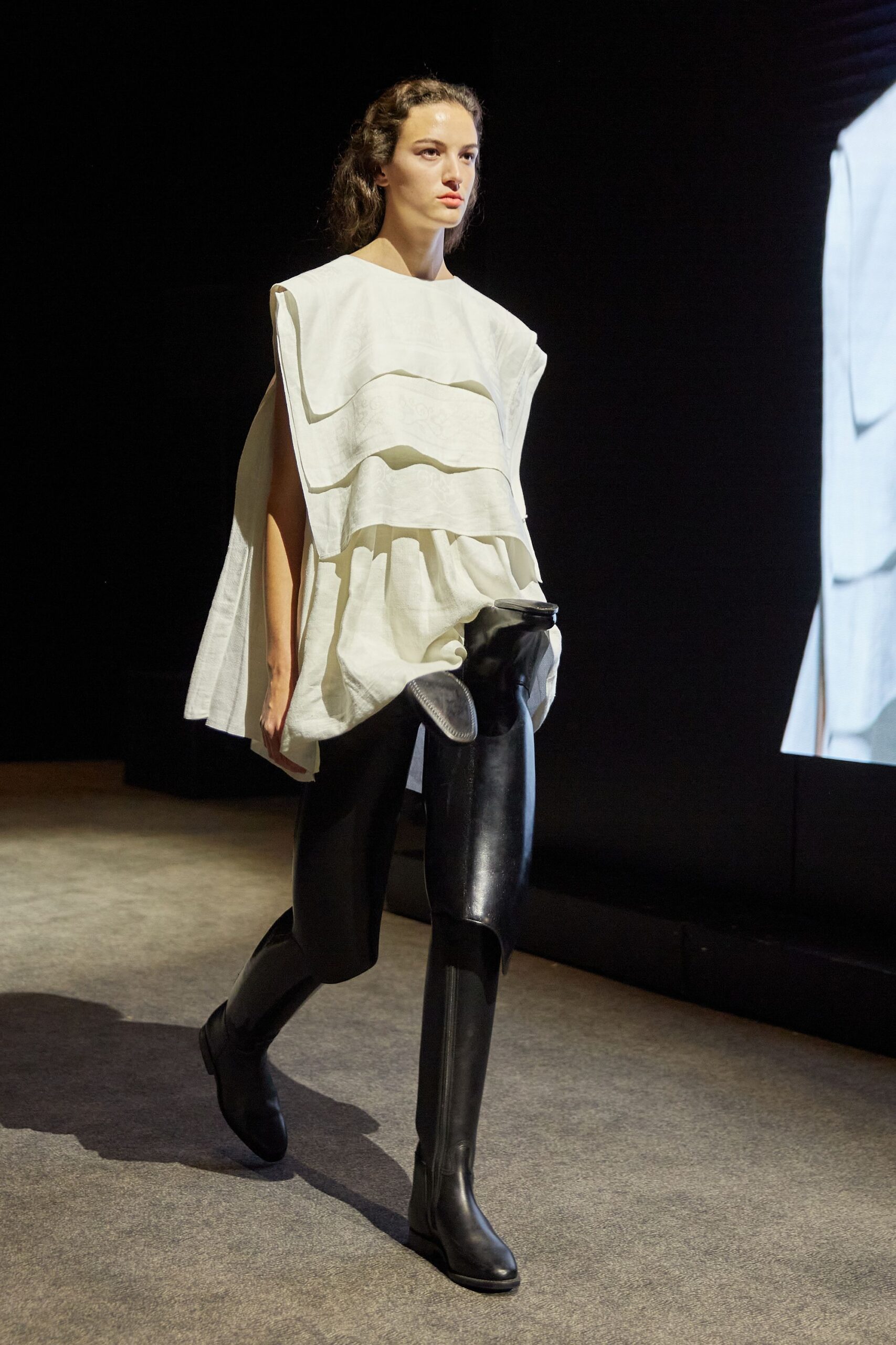 white layered top with black pants and boots
