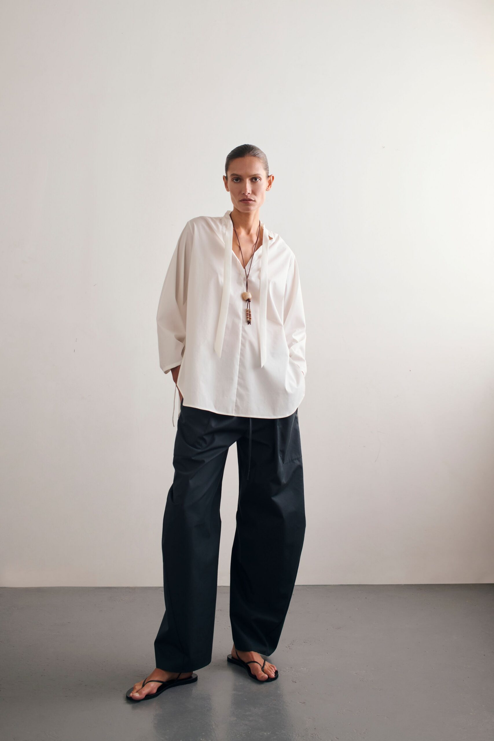 white relaxed shirt with black pants