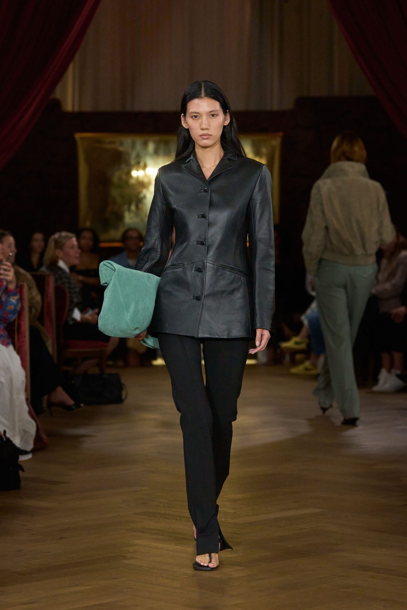black leather jacket with green bag