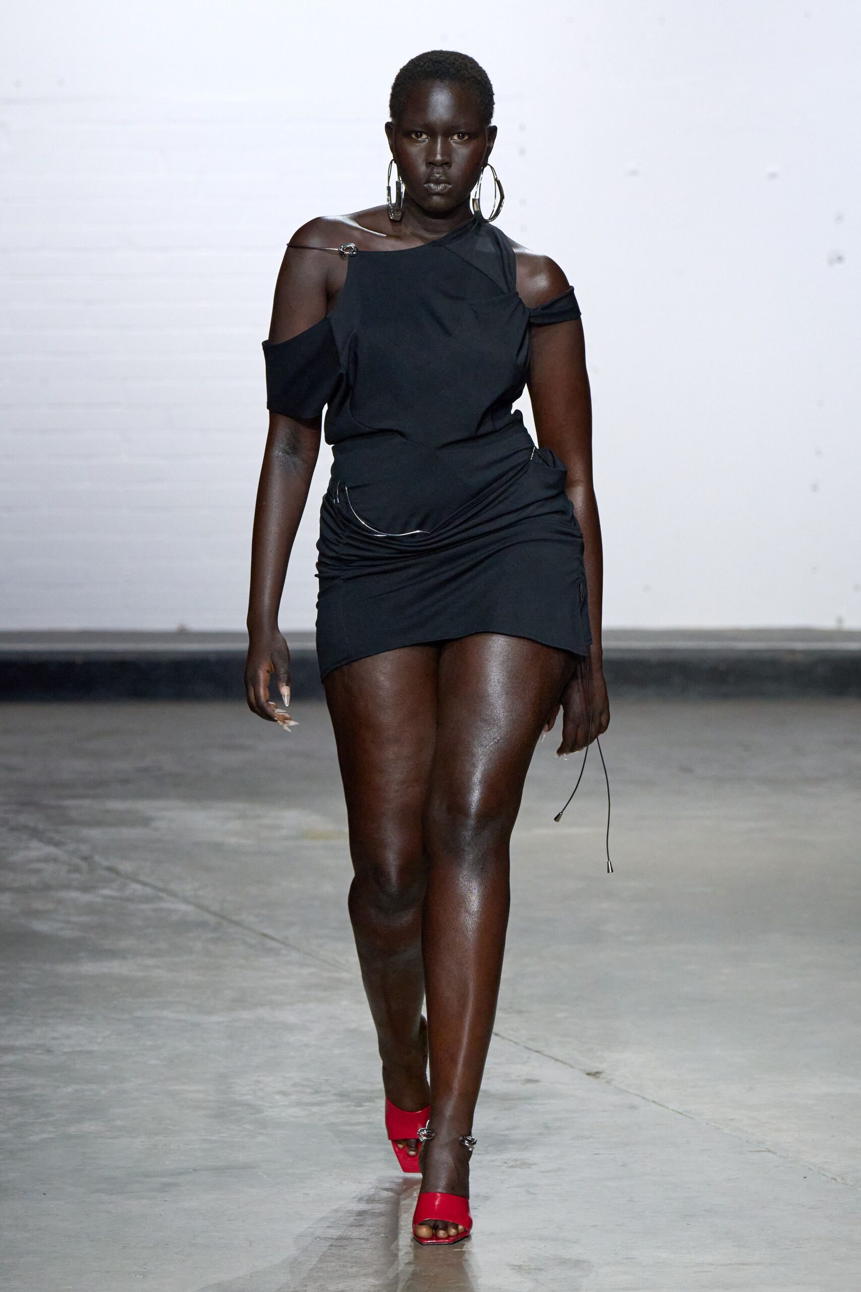 black off-shoulder mini dress with red shoes