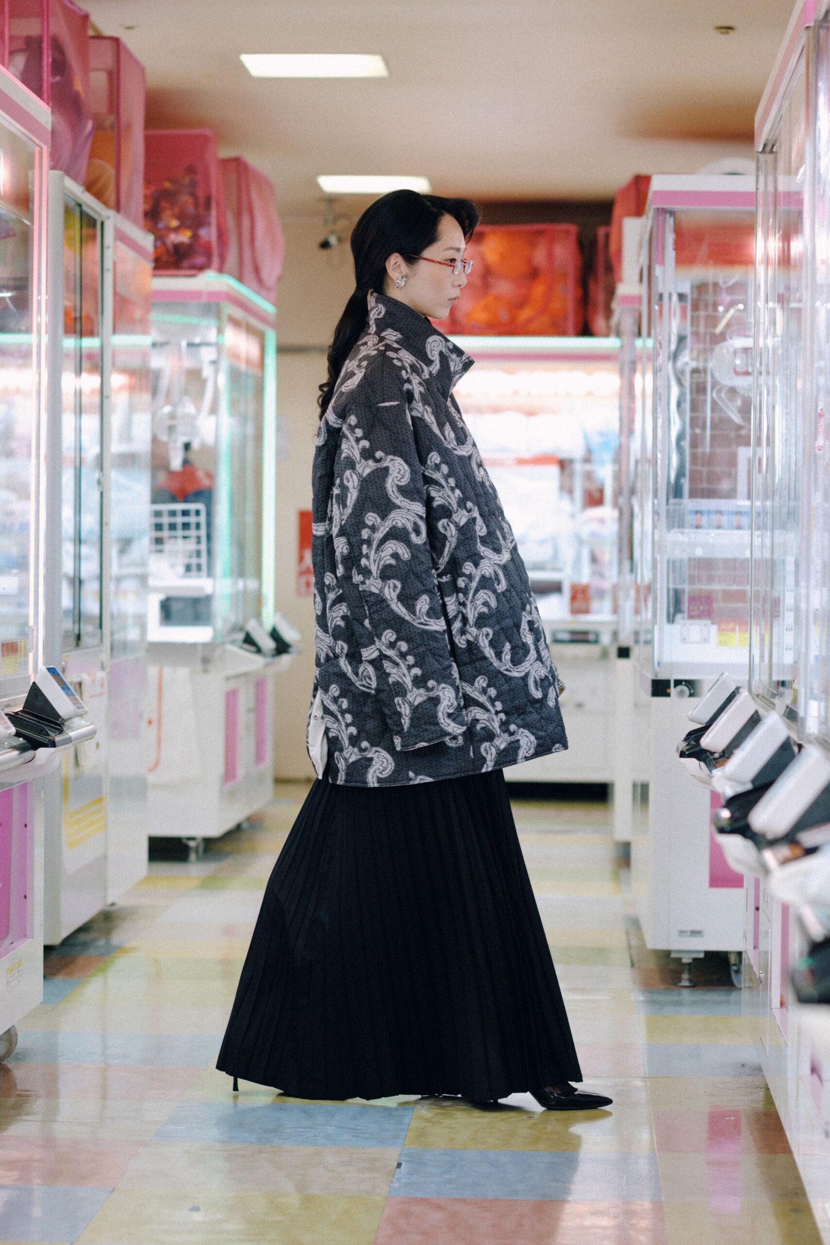 embroidered black coat with pleated skirt
