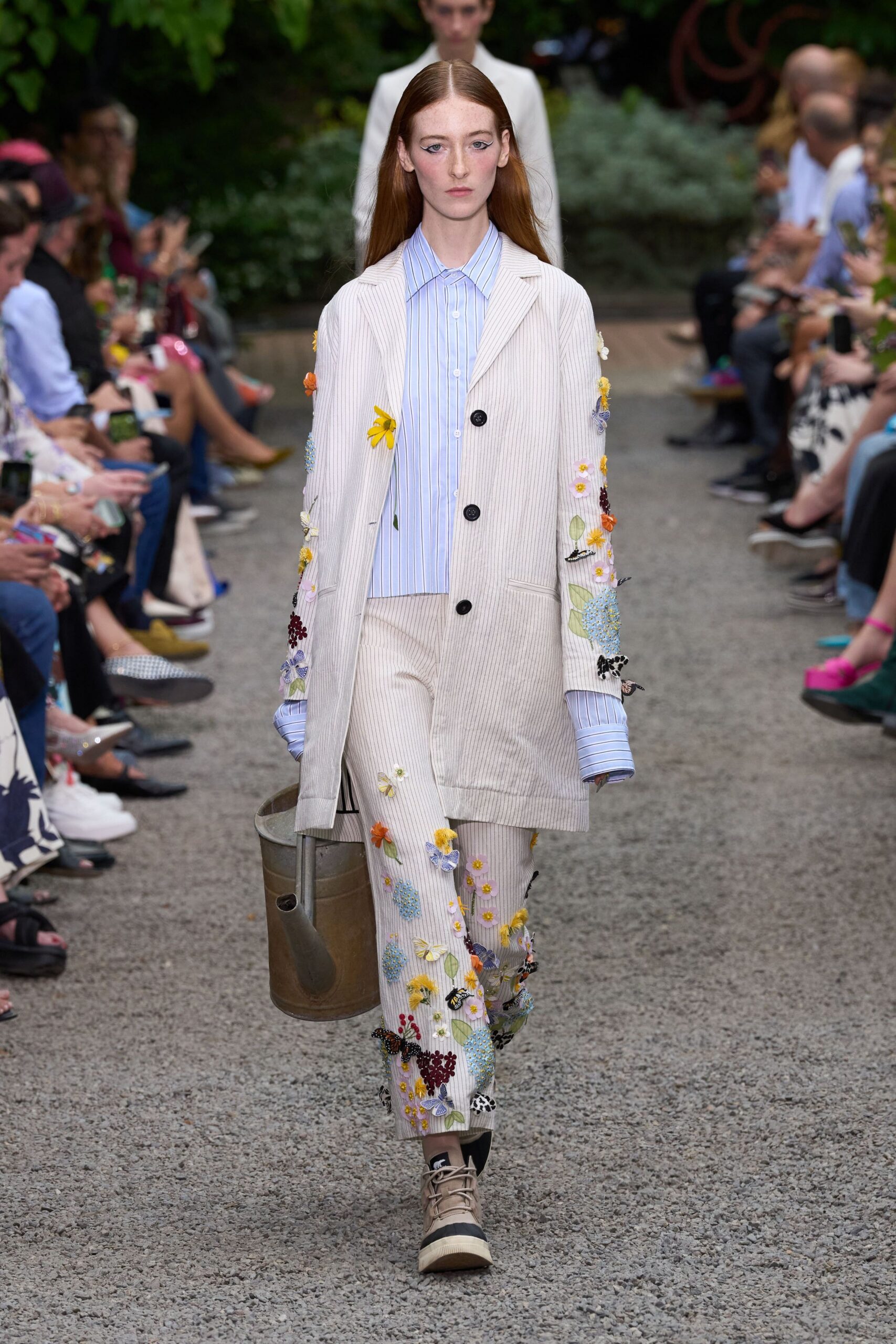beige embroidered coat with blue shirt