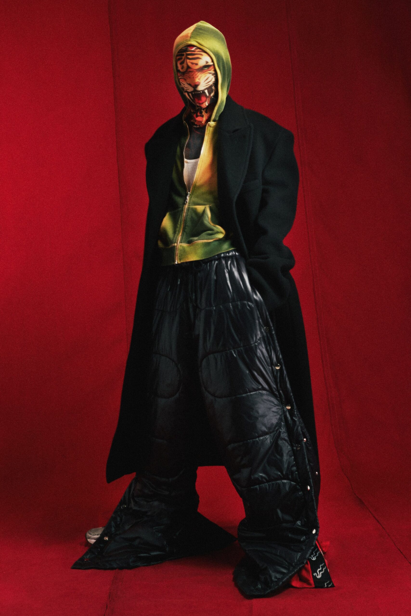 black coat green hoodie relaxed pants