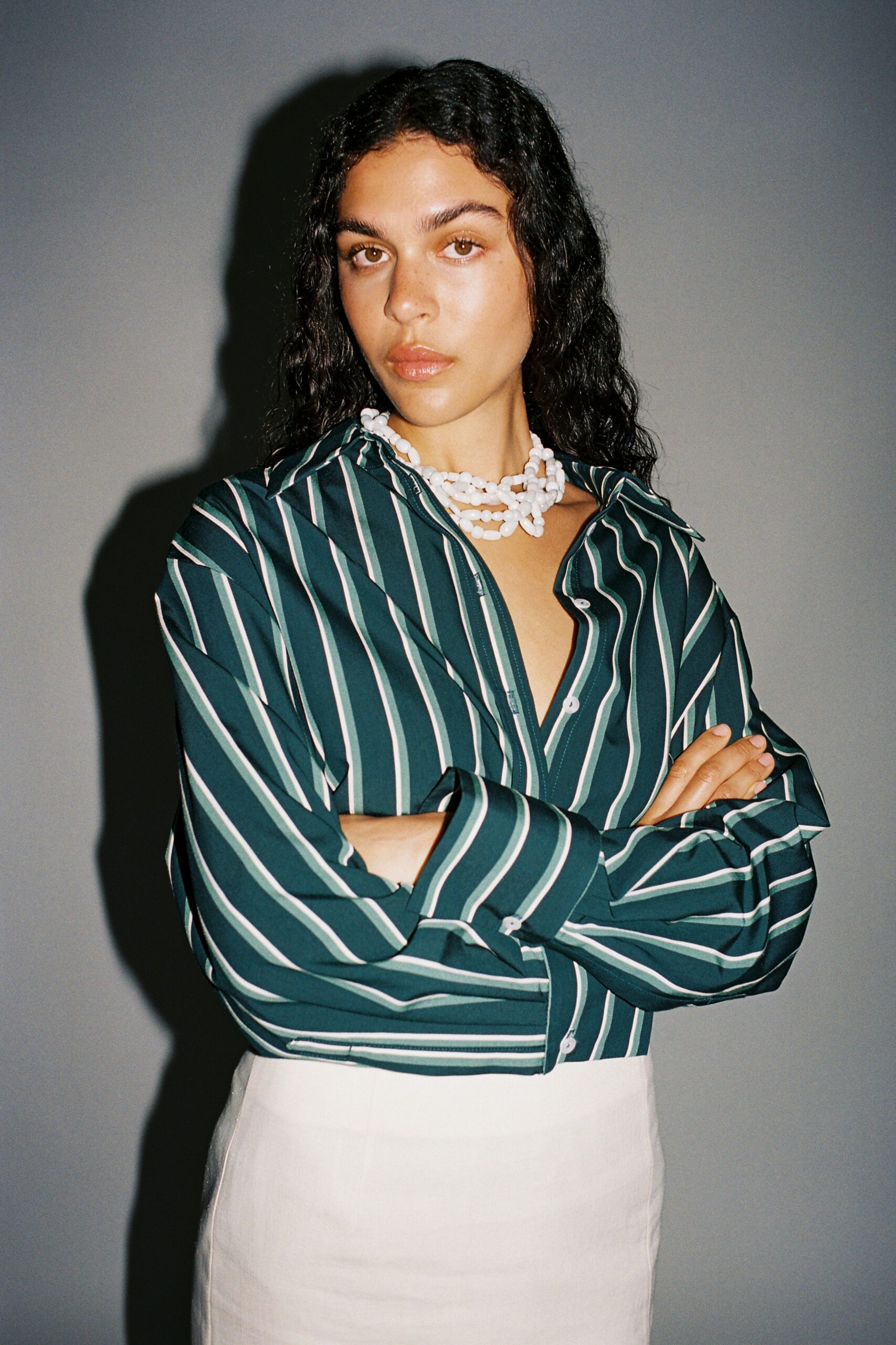 green striped shirt and white skirt