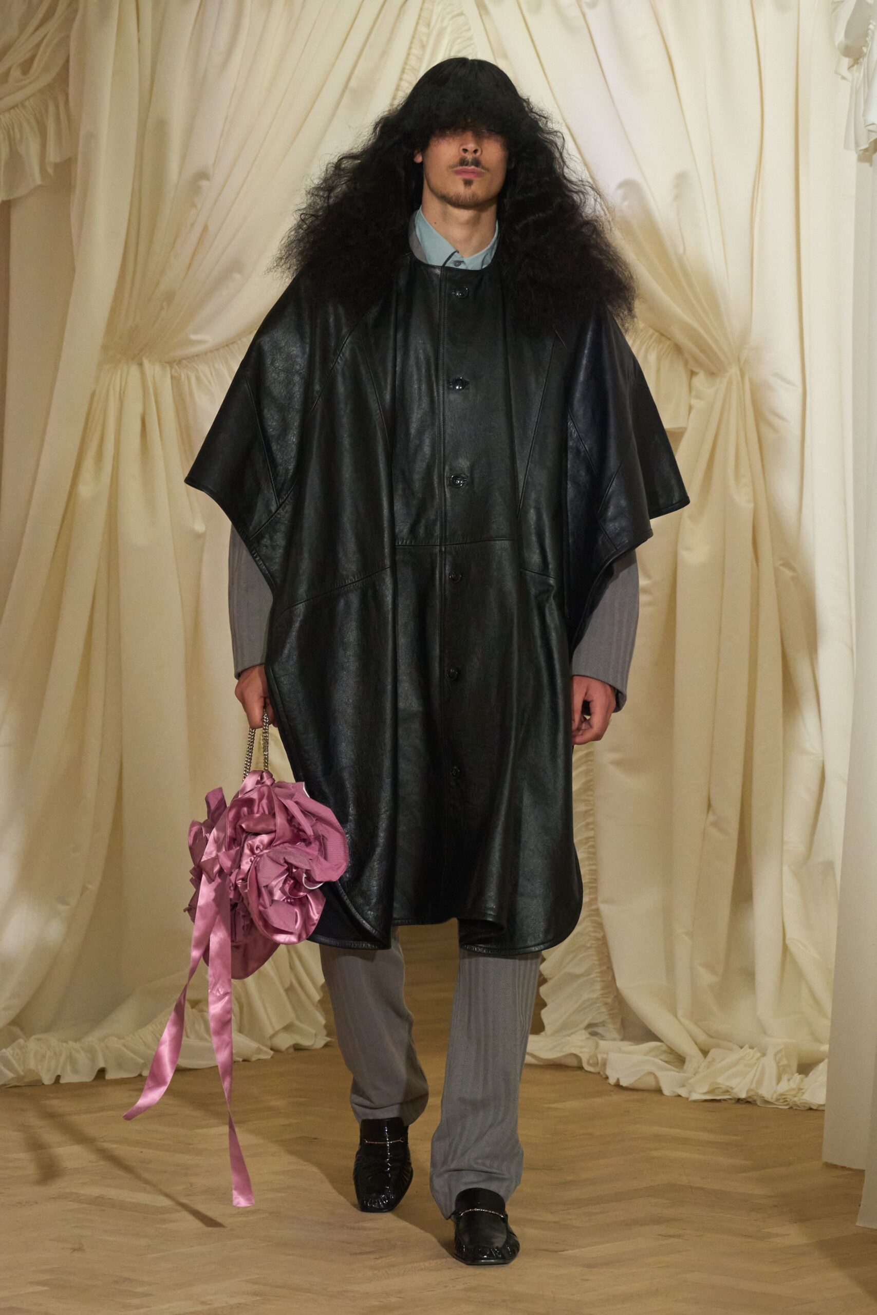 black leather coat with pink bag