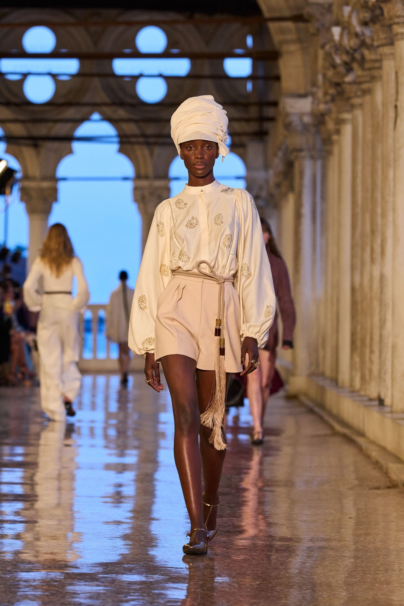 white embroidered blouse with beige shorts