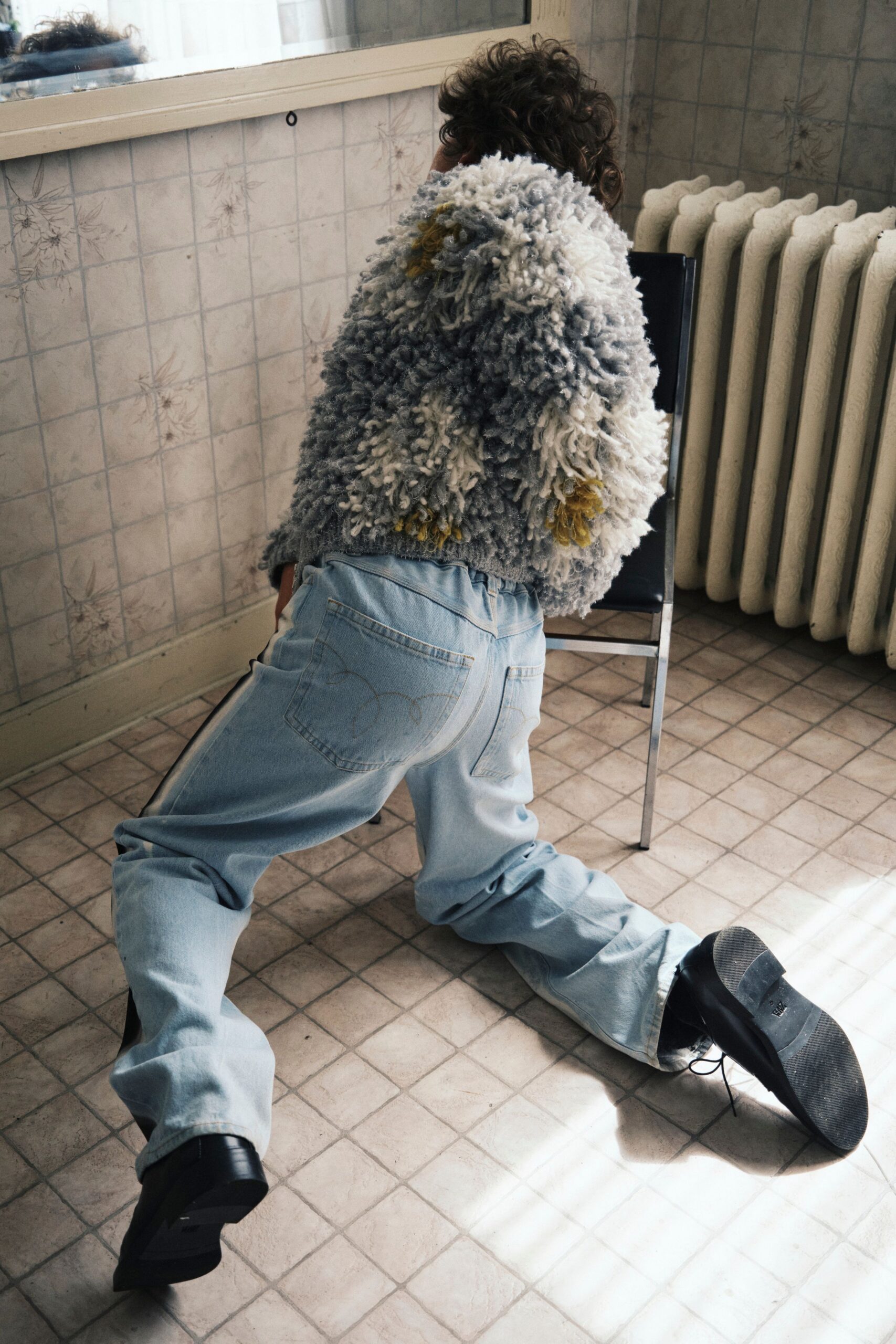 gray wool relaxed sweater with blue jeans