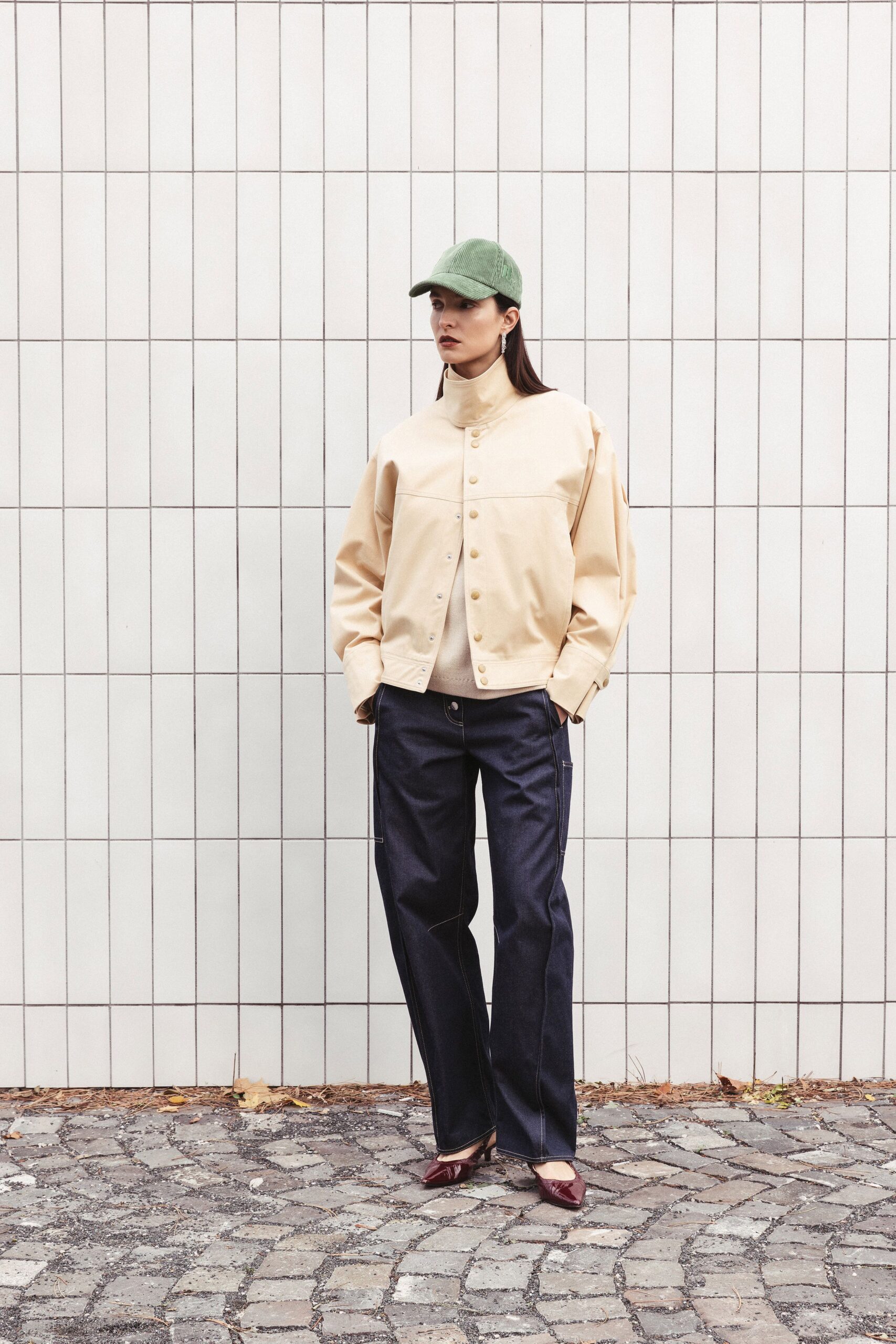 beige jacket navy pants red shoes green hat