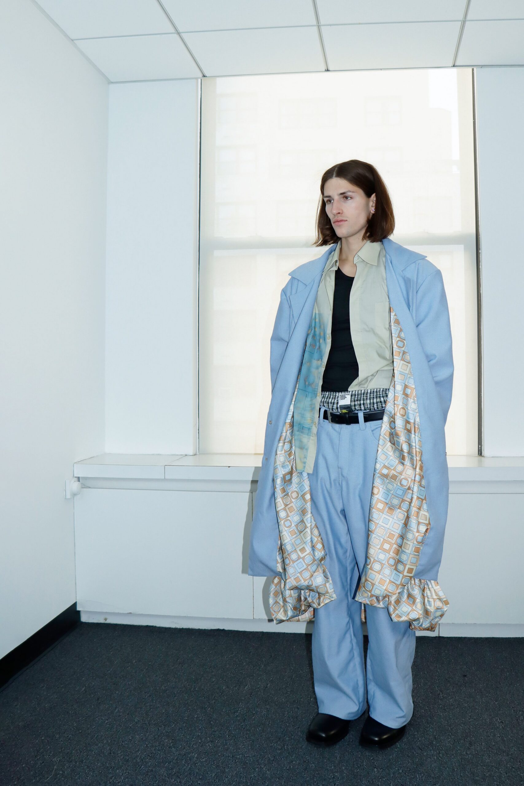blue relaxed coat with beige shirt