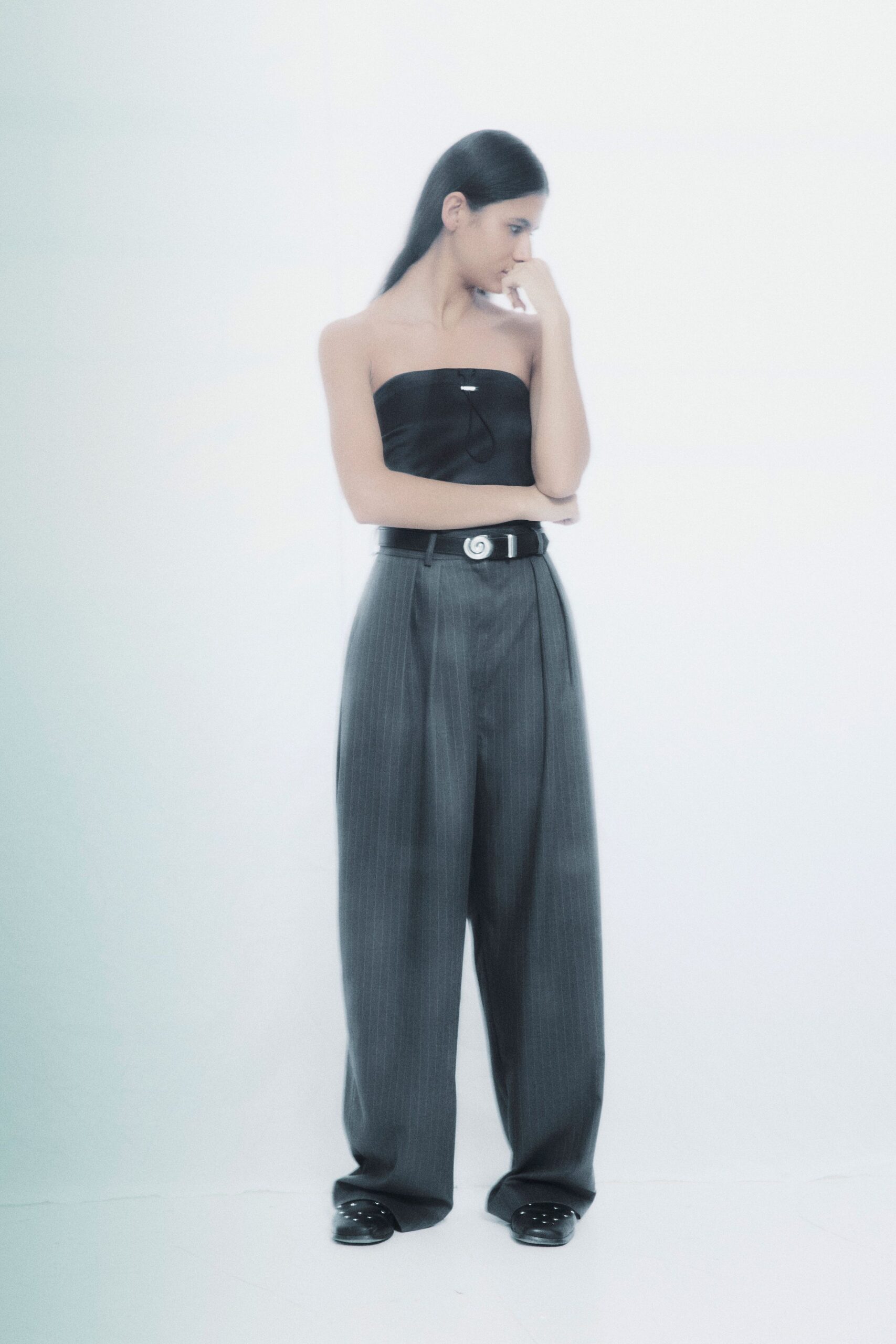 black strapless top gray relaxed pants