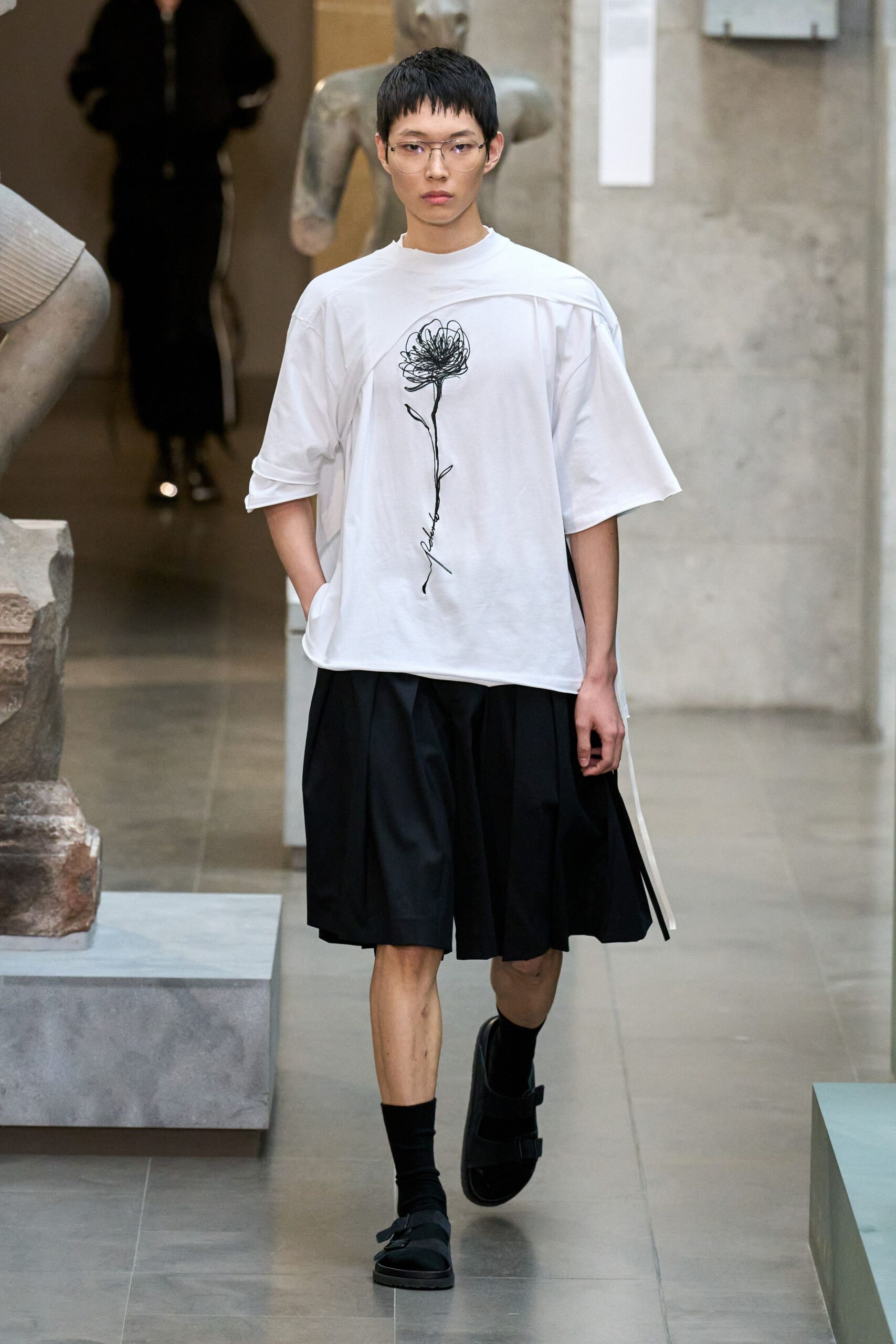 white relaxed top black pleated skirt