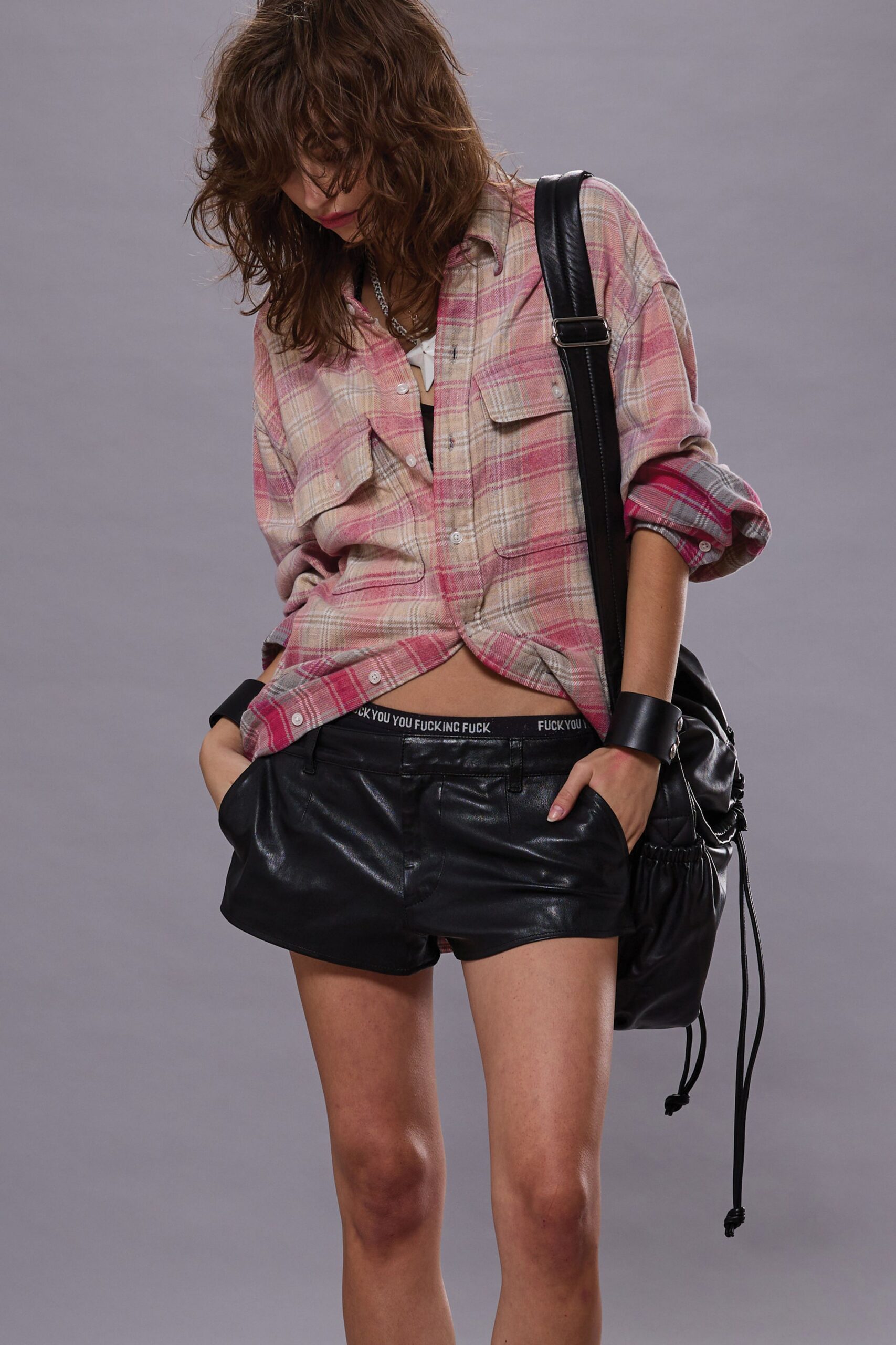 pink checked shirt with black shorts