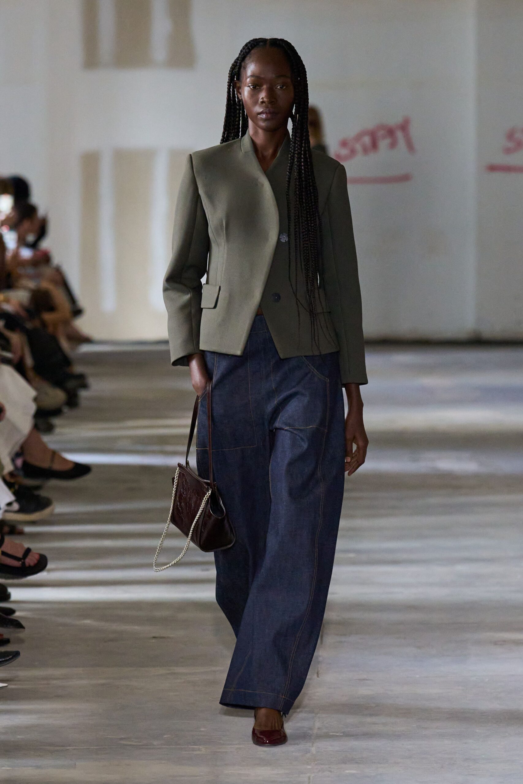 green tailored blazer with denim pants