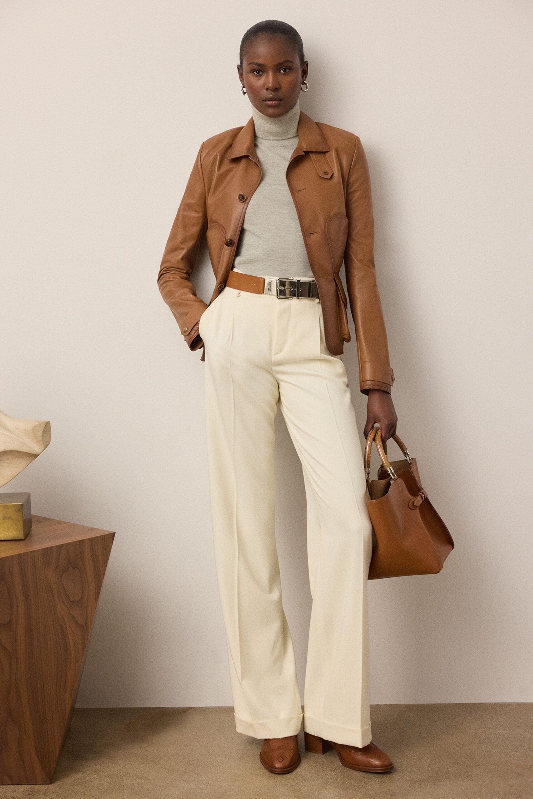 brown leather jacket with gray top