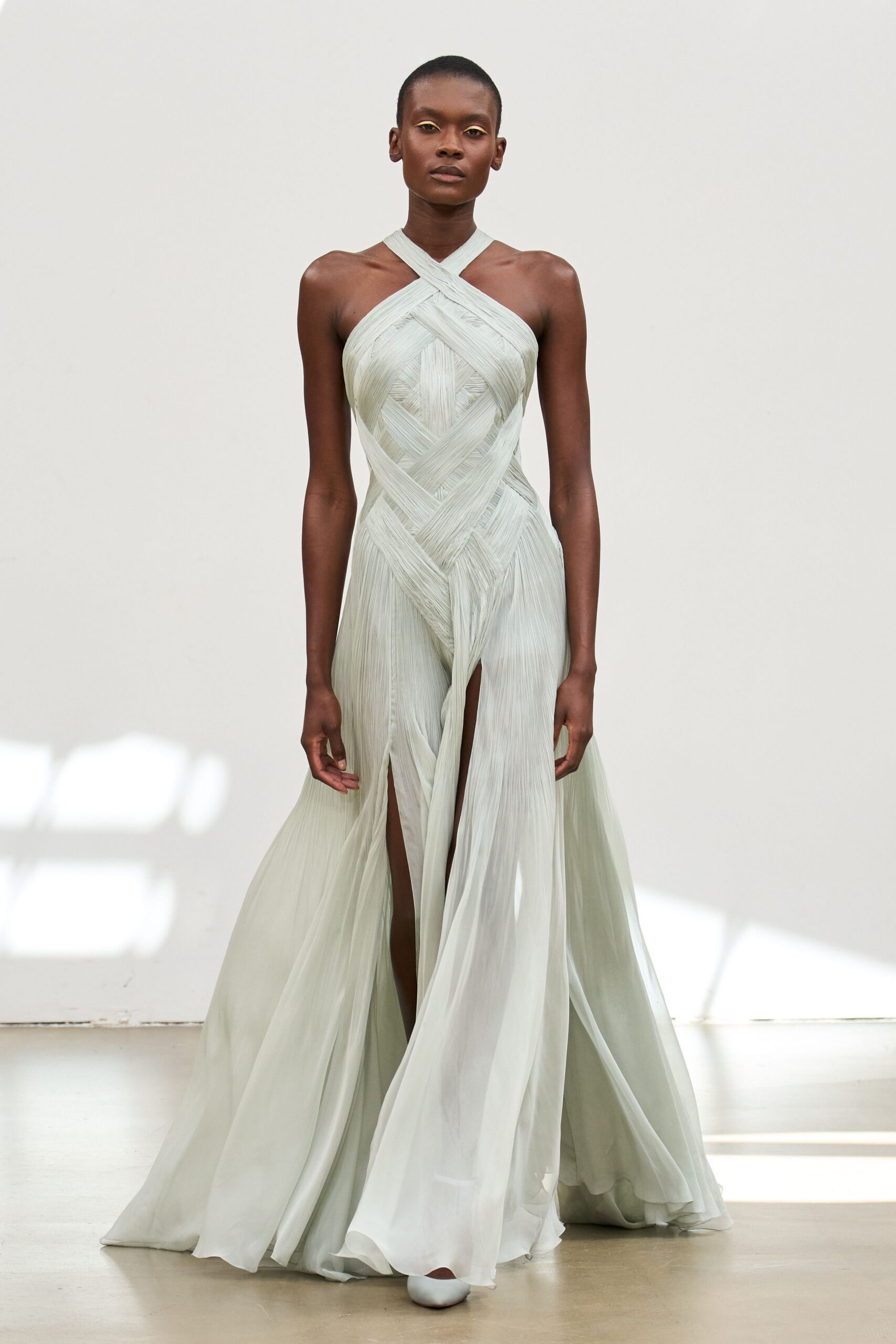 green silk sleeveless v-neck fitted pleated flowing gown