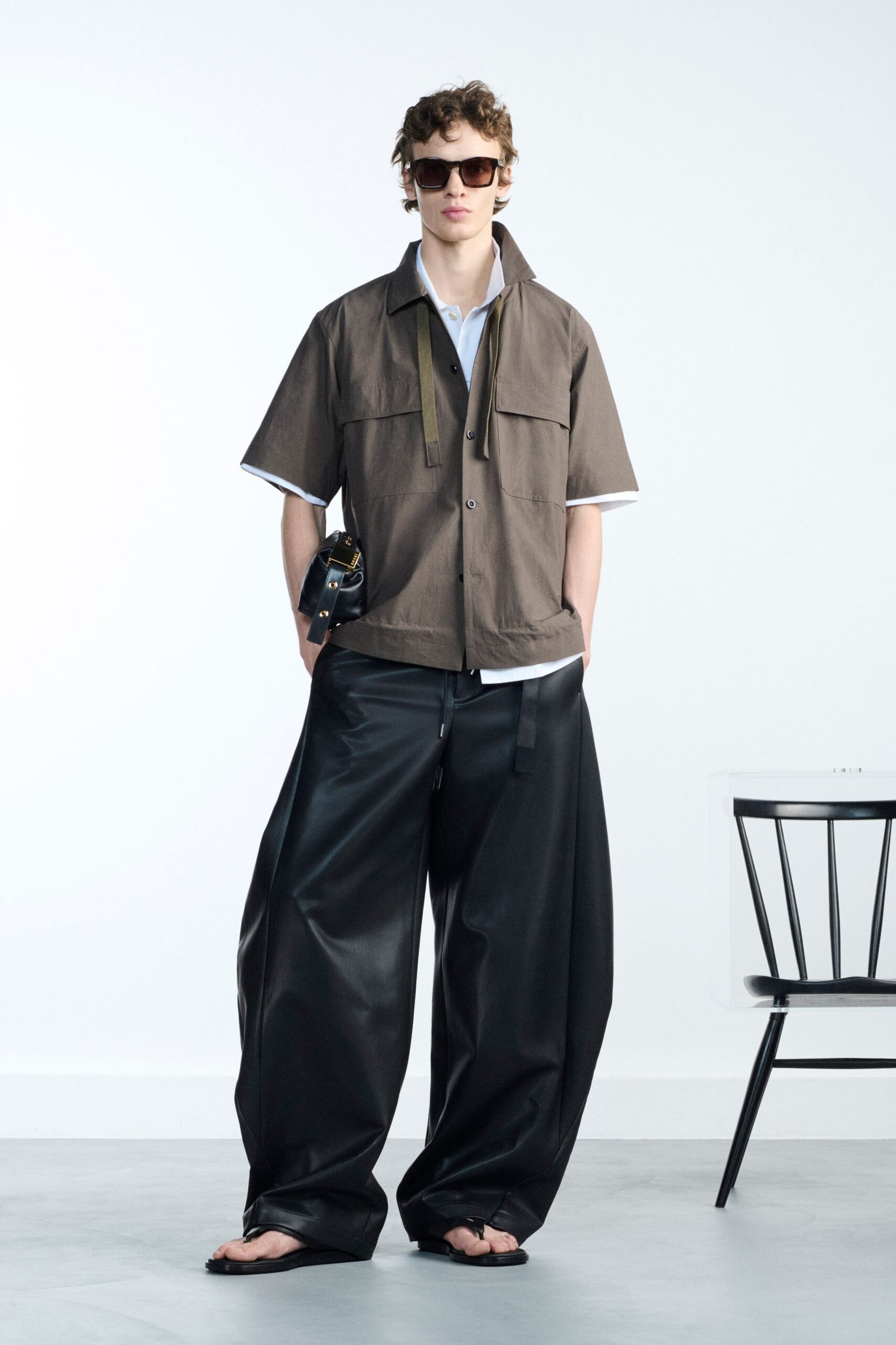 brown short-sleeve shirt with black pants