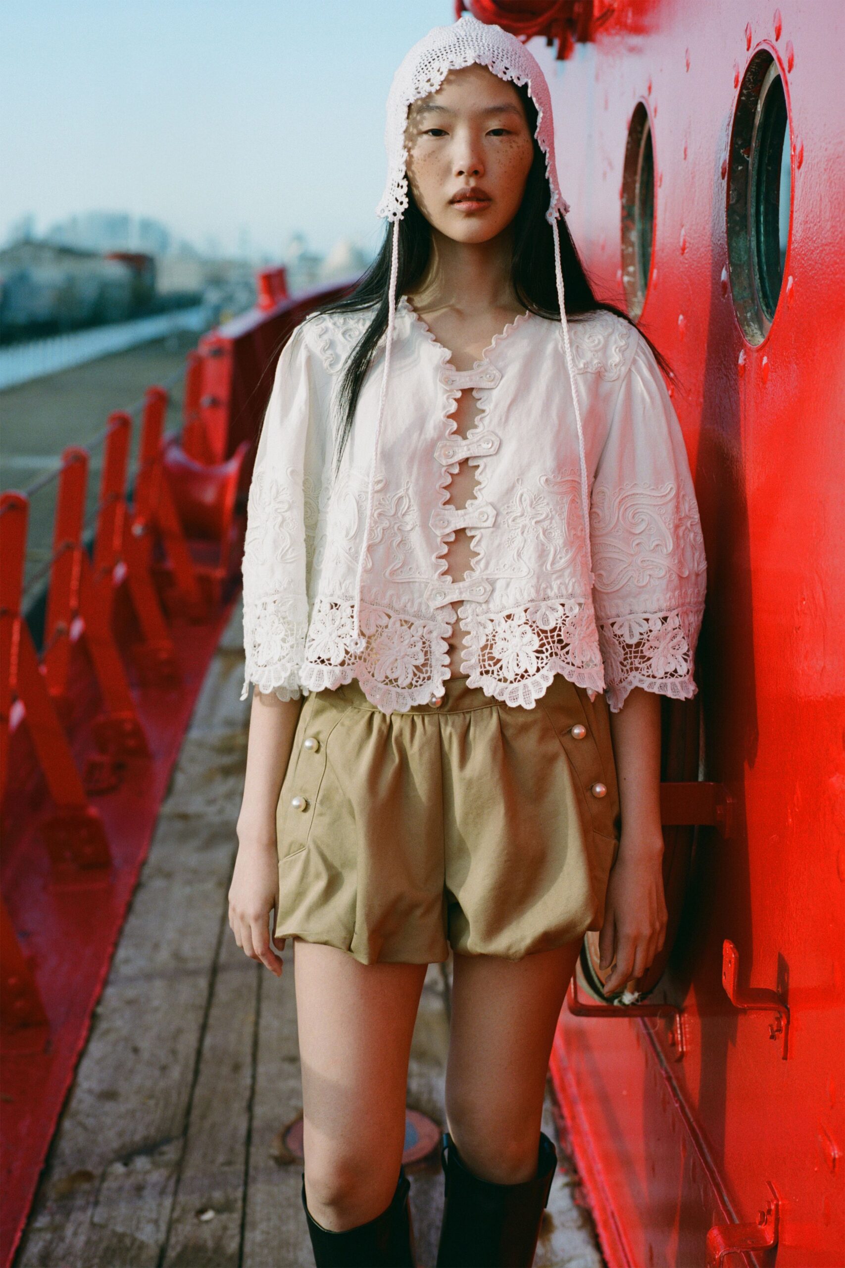 white embroidered blouse with beige shorts