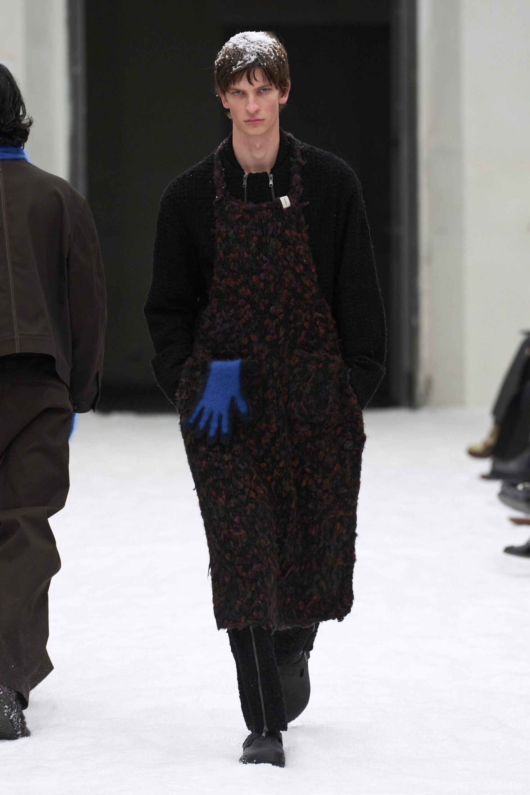 black wool relaxed jumpsuit with blue gloves