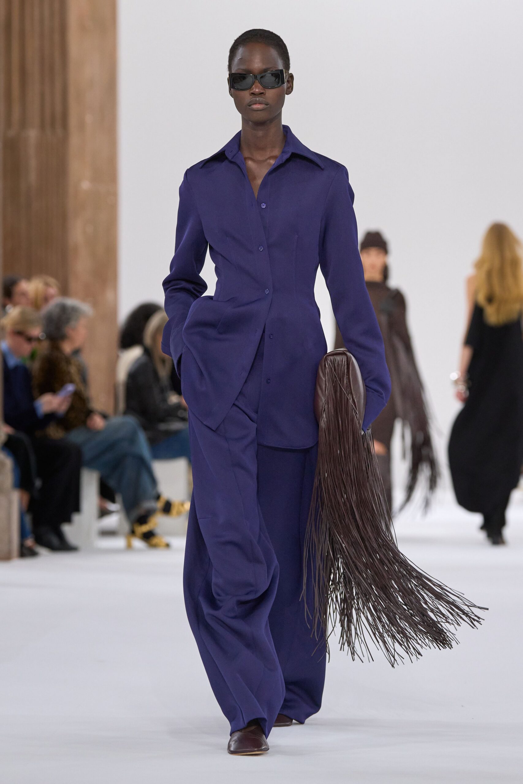 purple relaxed suit with fringed bag