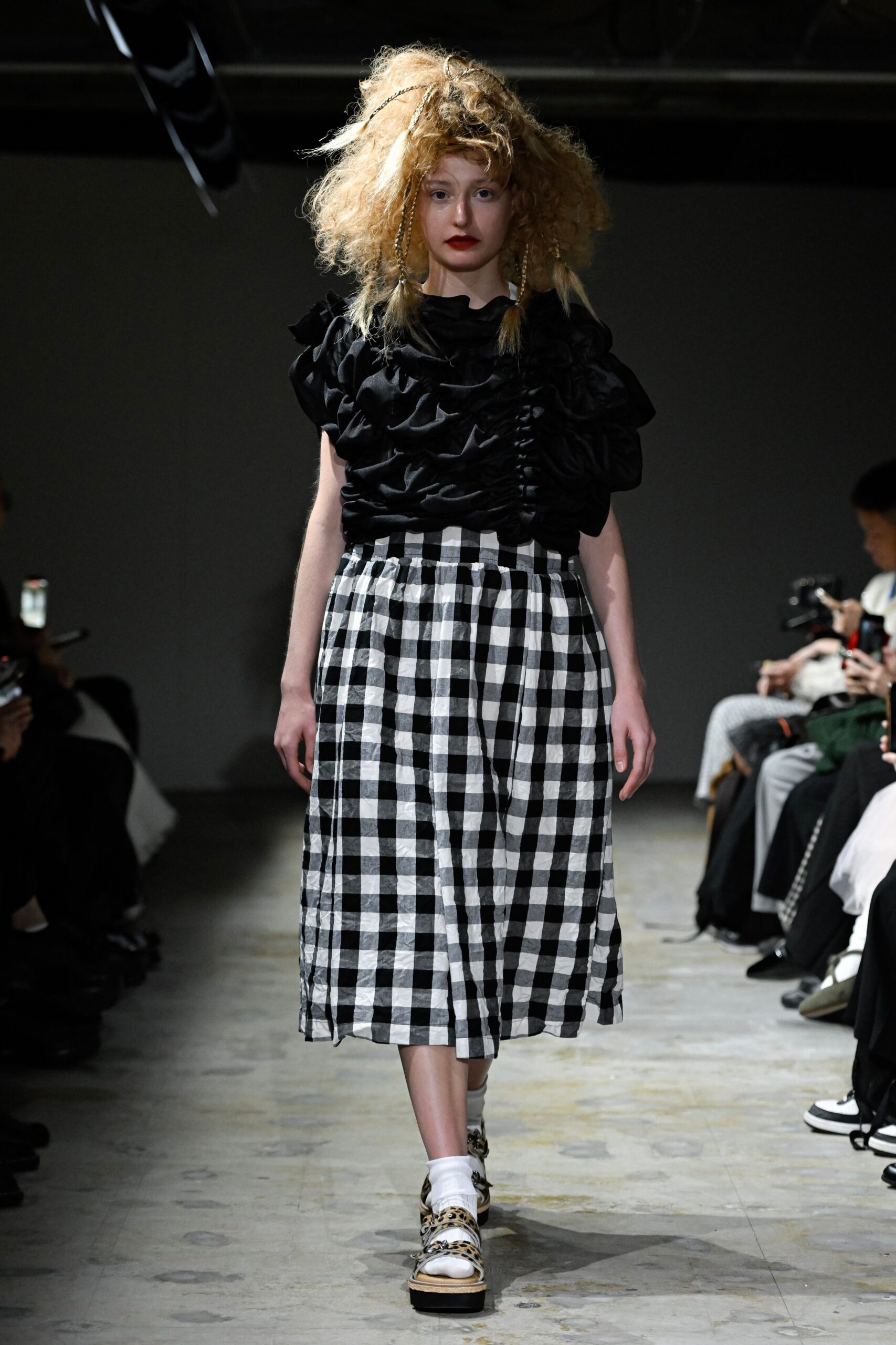 black ruffled top with checked skirt