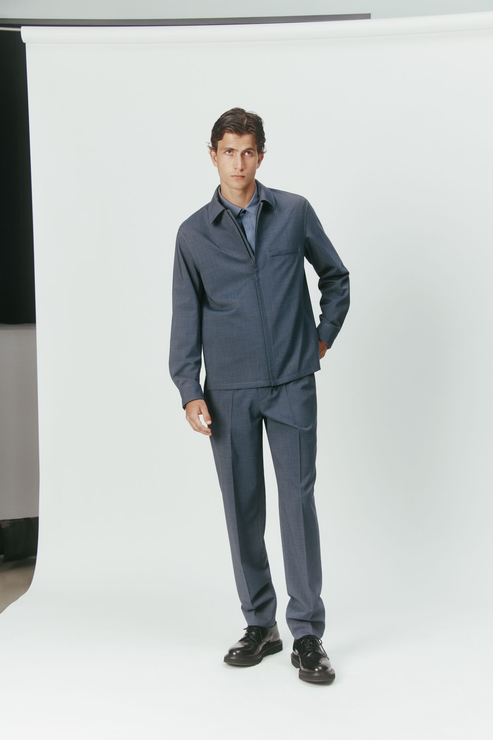 blue cotton long-sleeve collared structured buttoned jacket