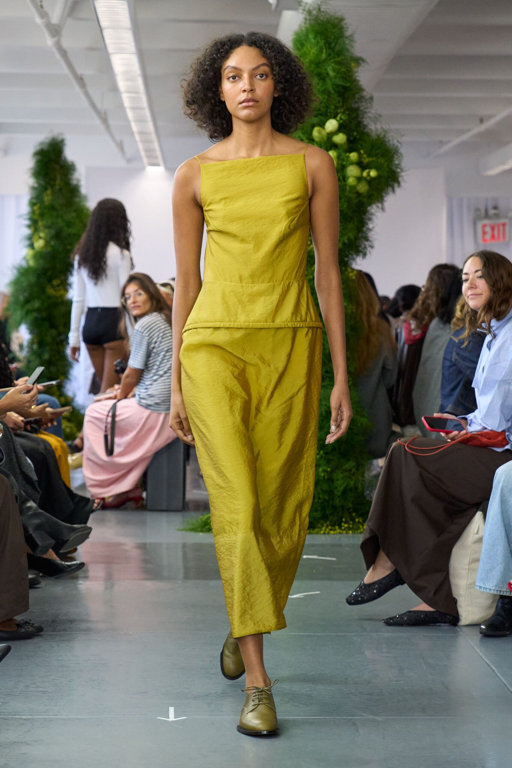 yellow fitted midi dress with brown shoes
