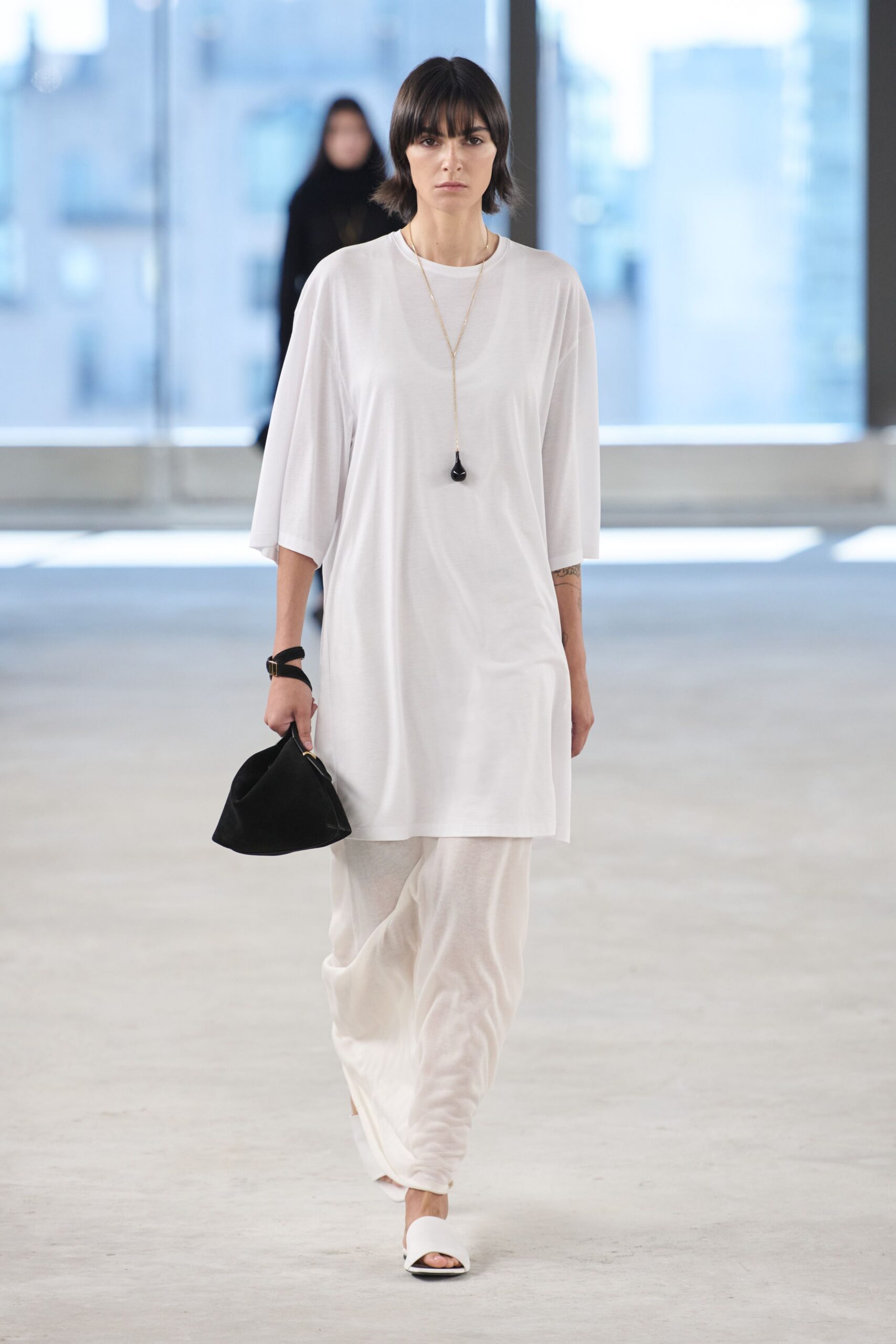 white relaxed midi dress with black bag