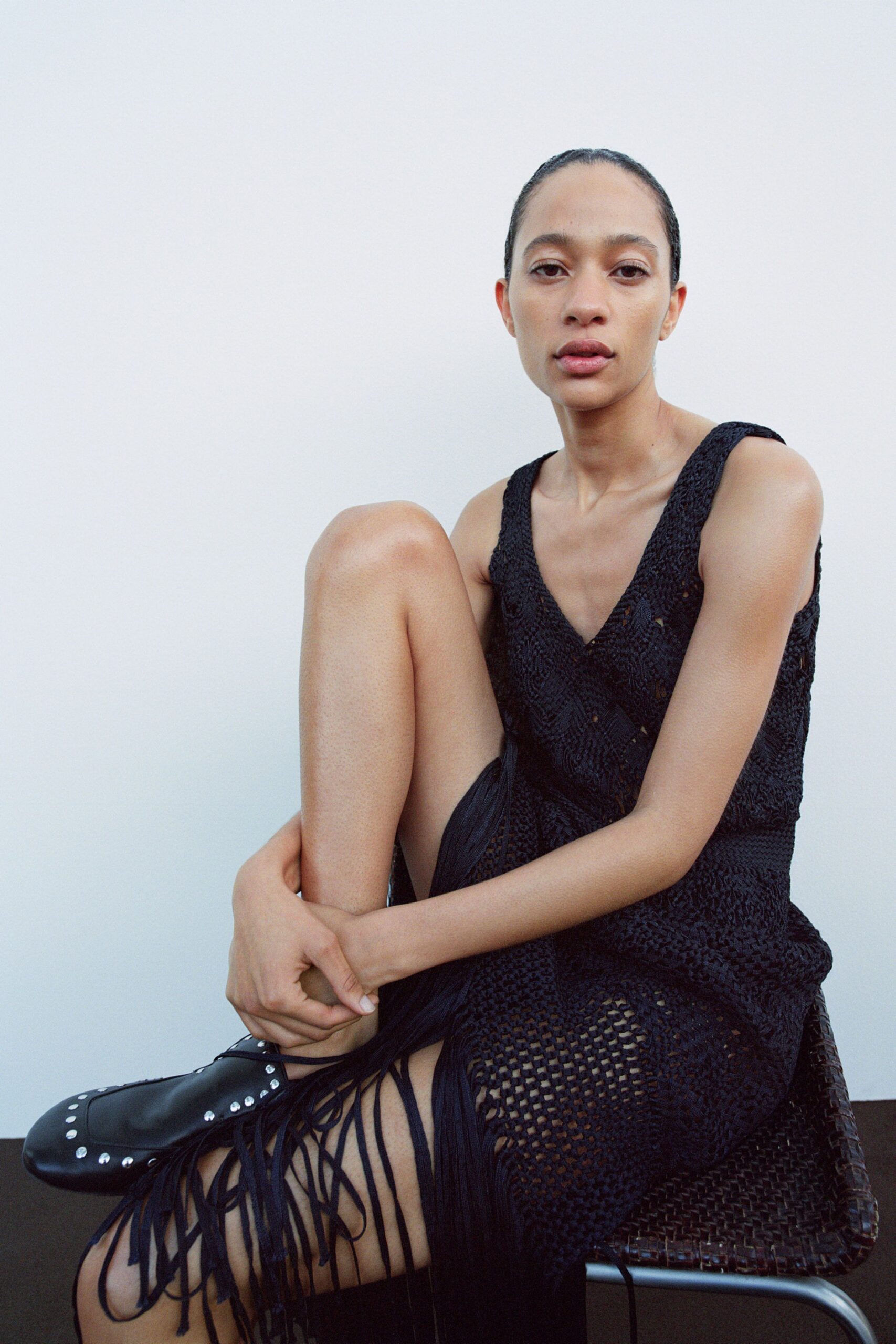 black fitted sleeveless dress with fringes