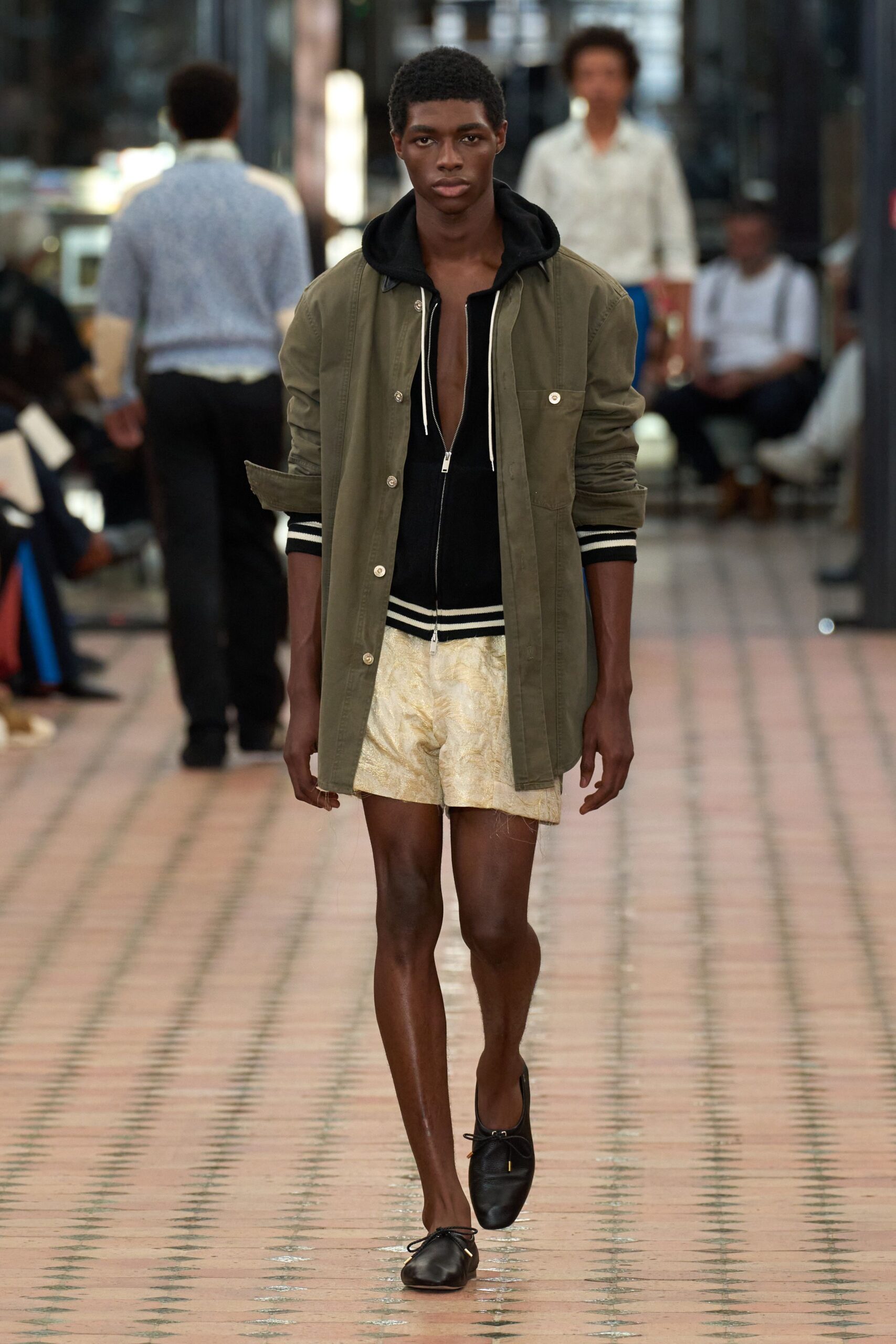 green jacket black hoodie beige shorts