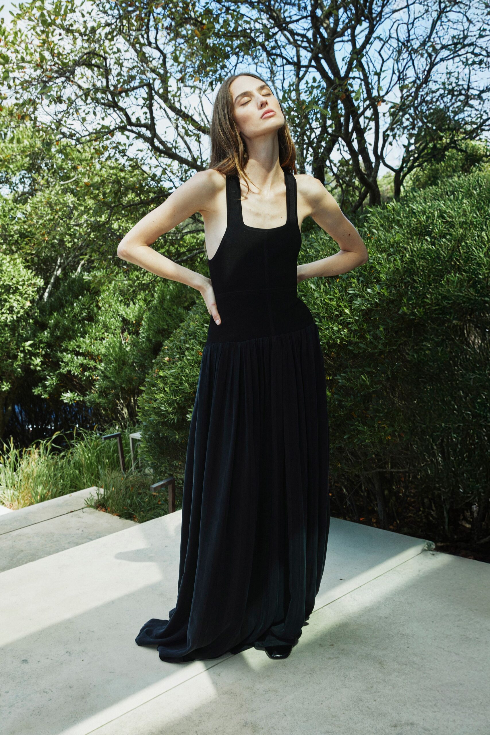 black sleeveless pleated gown