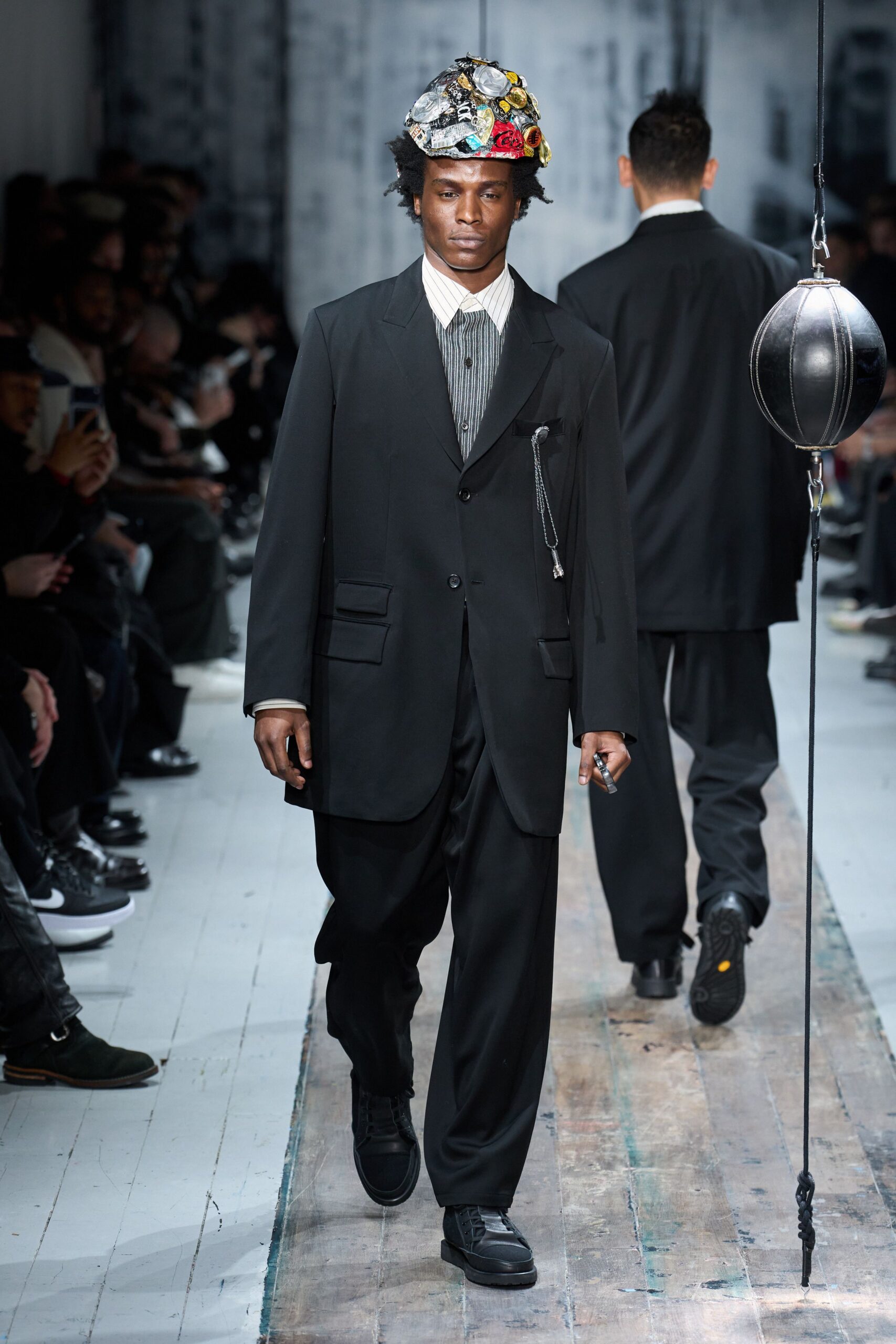 black tailored suit with multi-colored hat