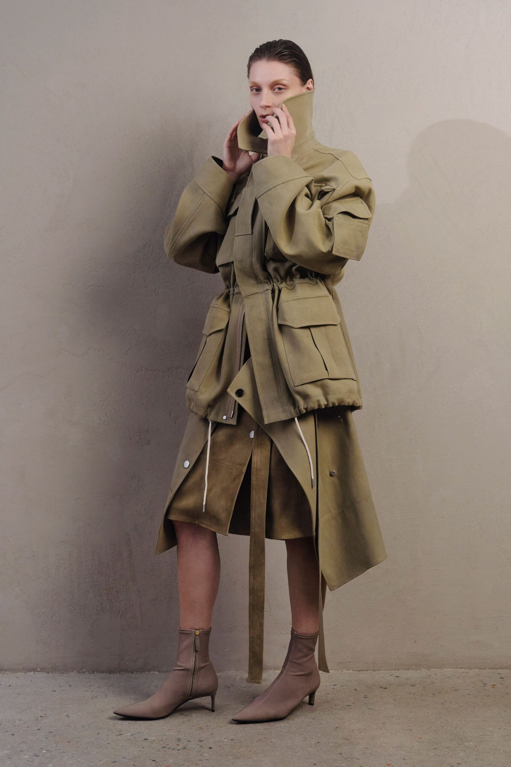 oversized green coat with beige skirt