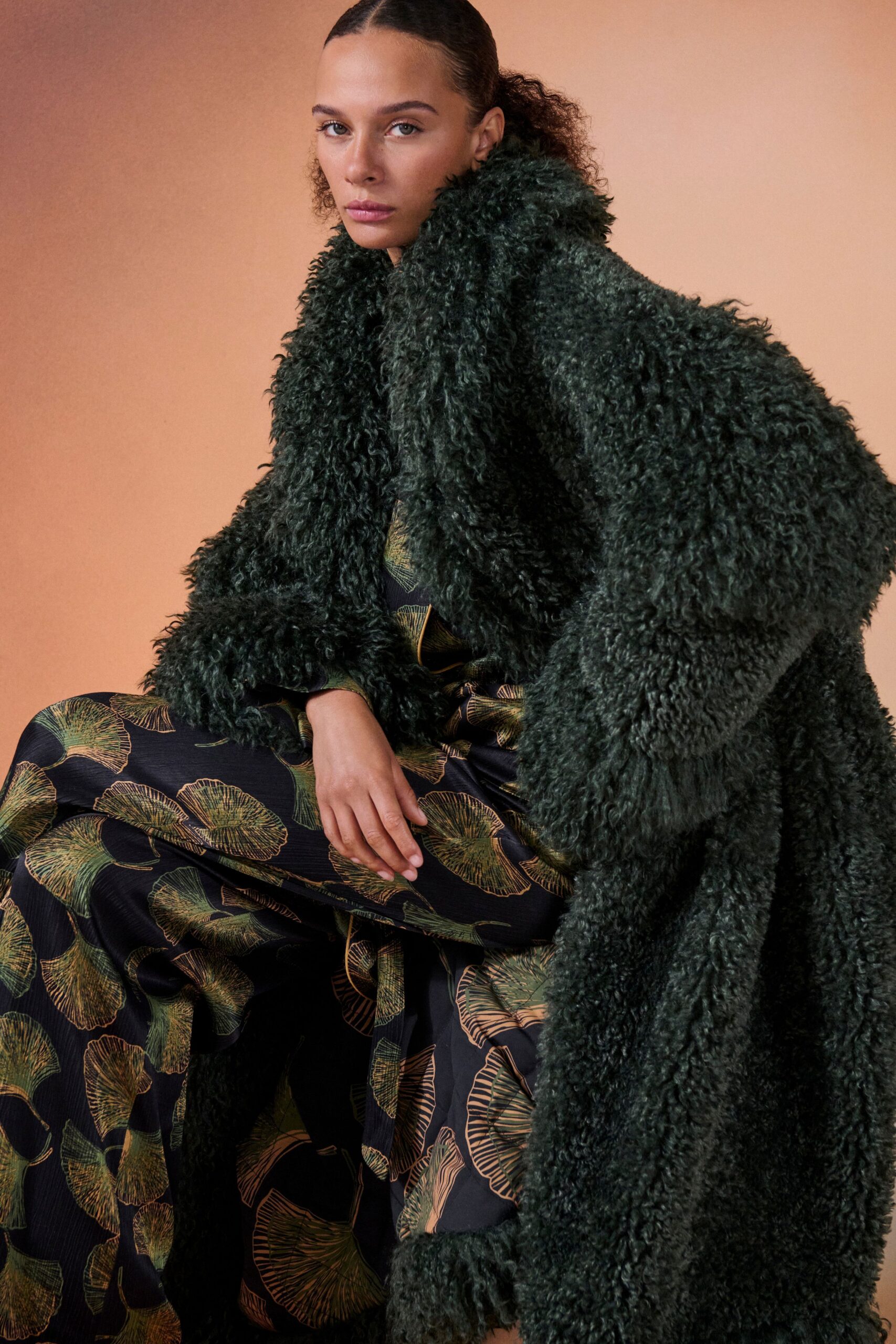 green faux-fur coat and black dress