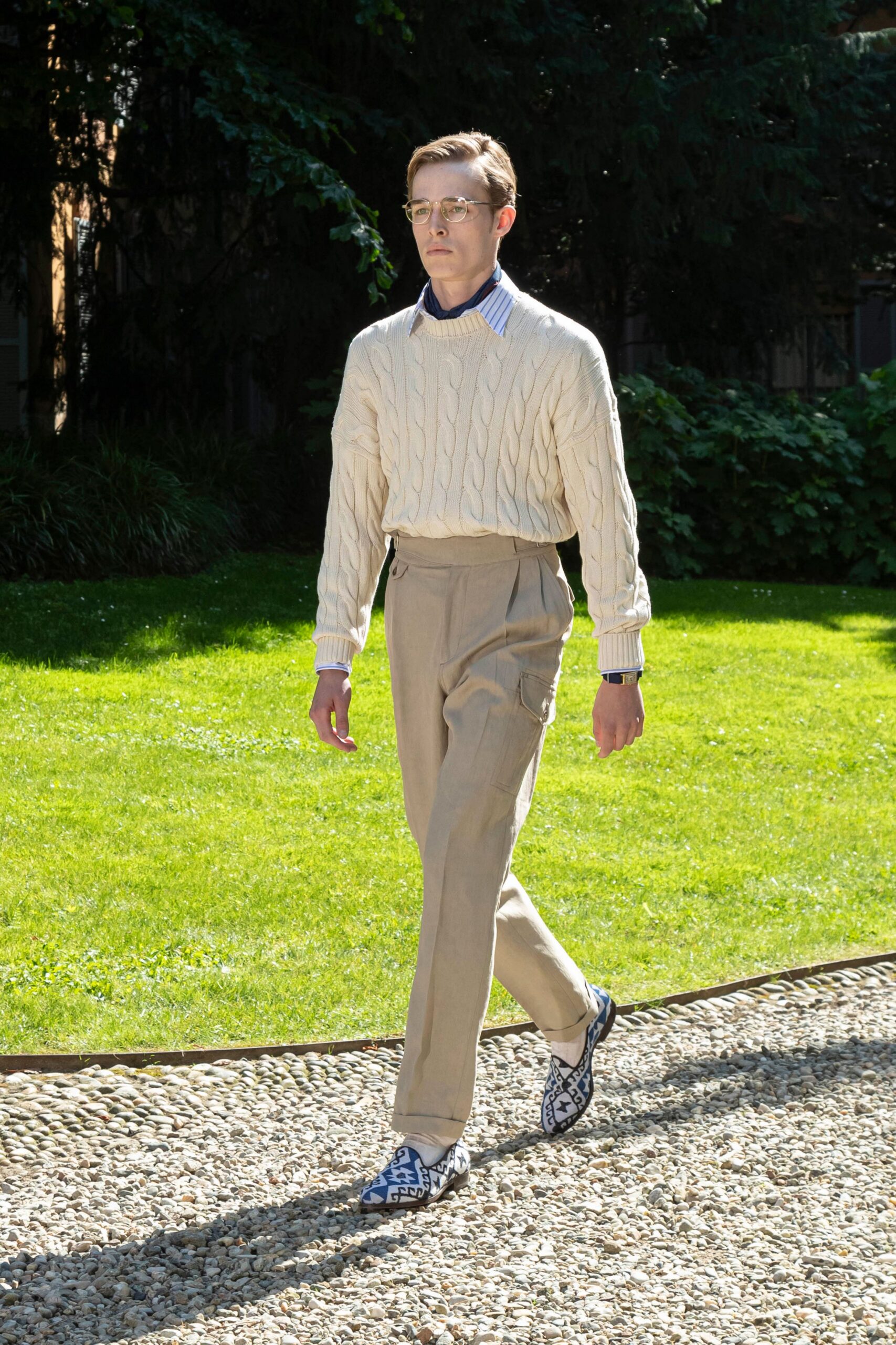 beige cable-knit sweater and relaxed pants