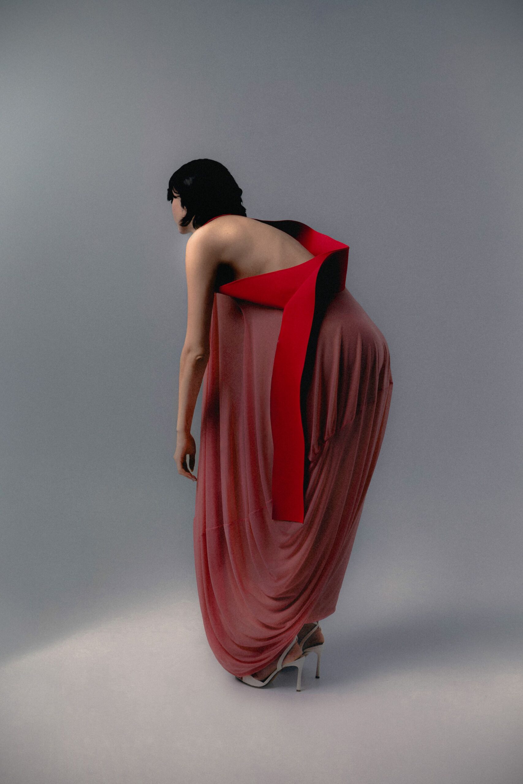 red silk sleeveless backless relaxed draped flowing gown