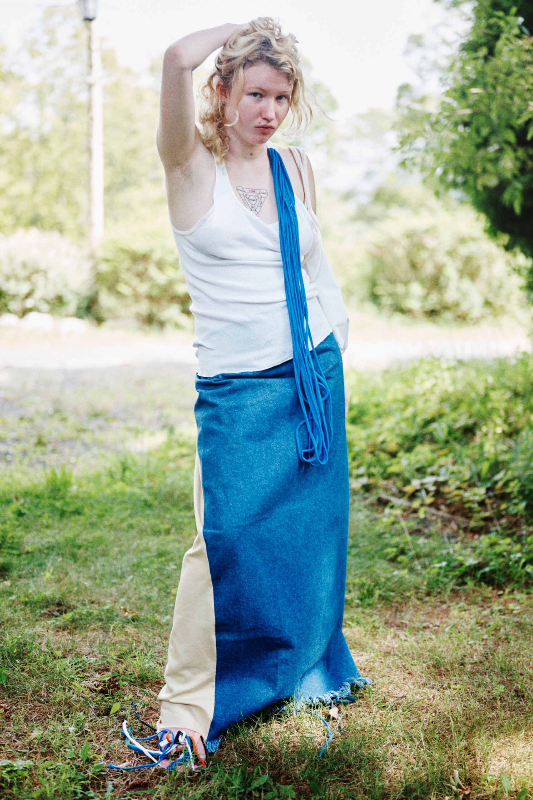 white fitted top with blue beige skirt