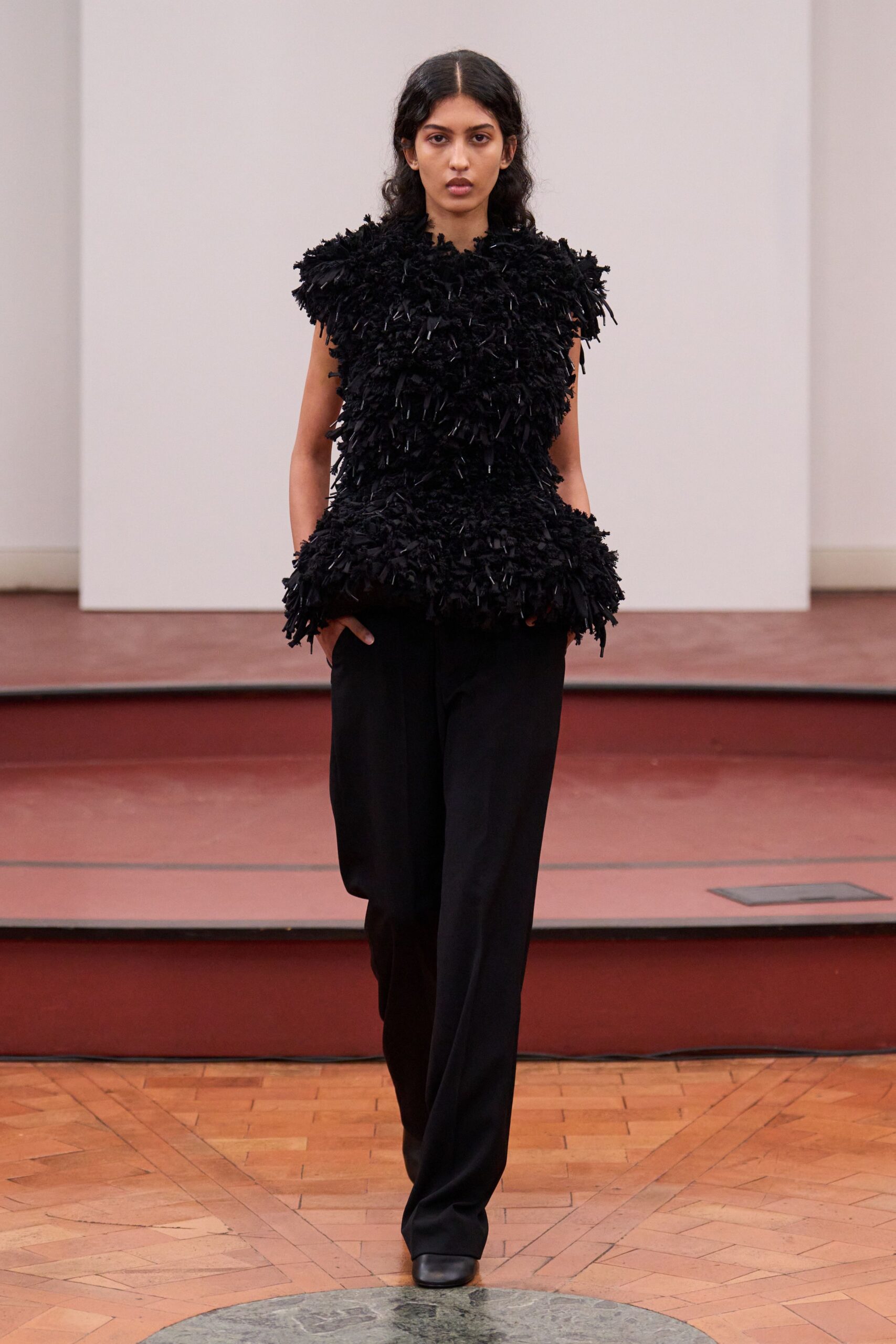 black ruffled top with relaxed pants