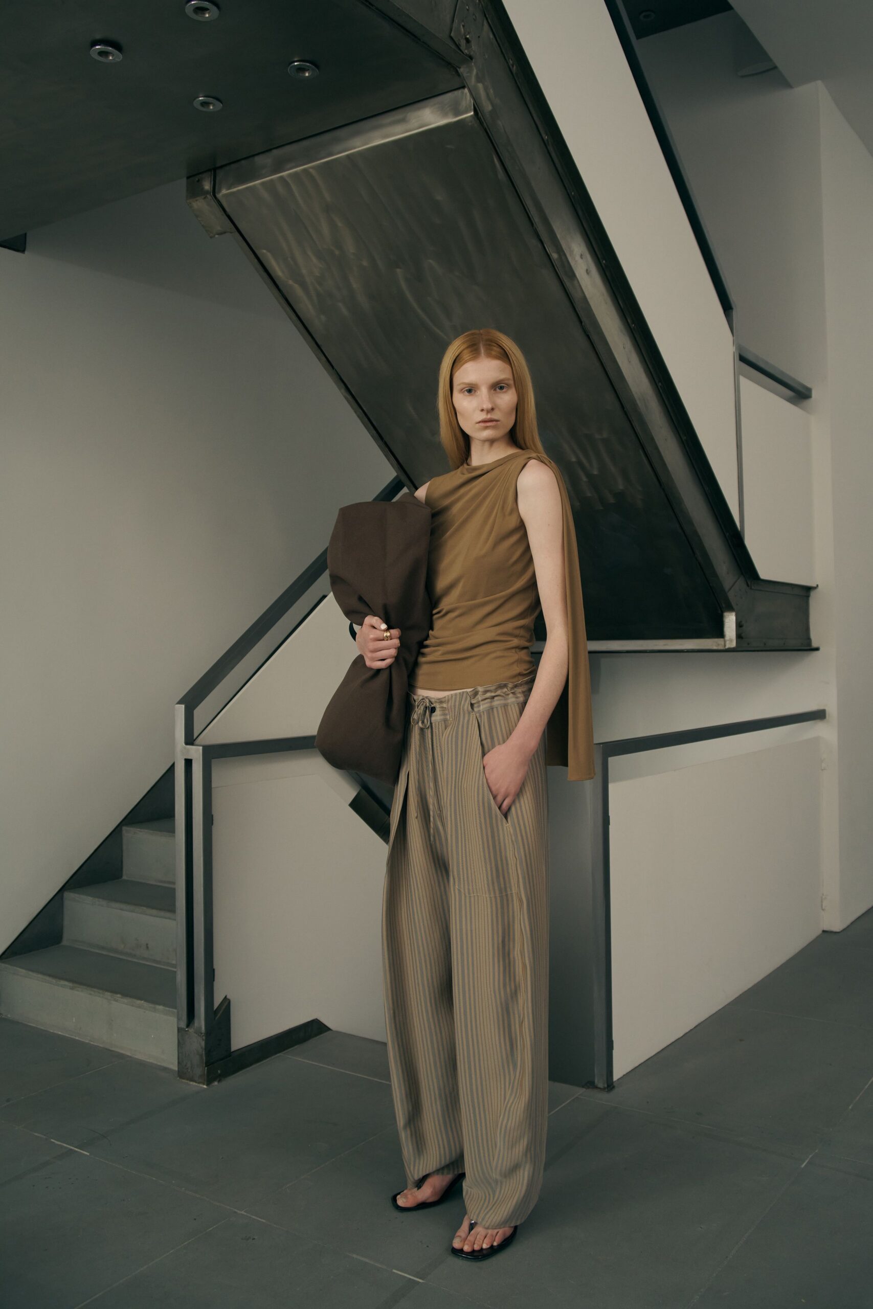 brown sleeveless top with striped pants