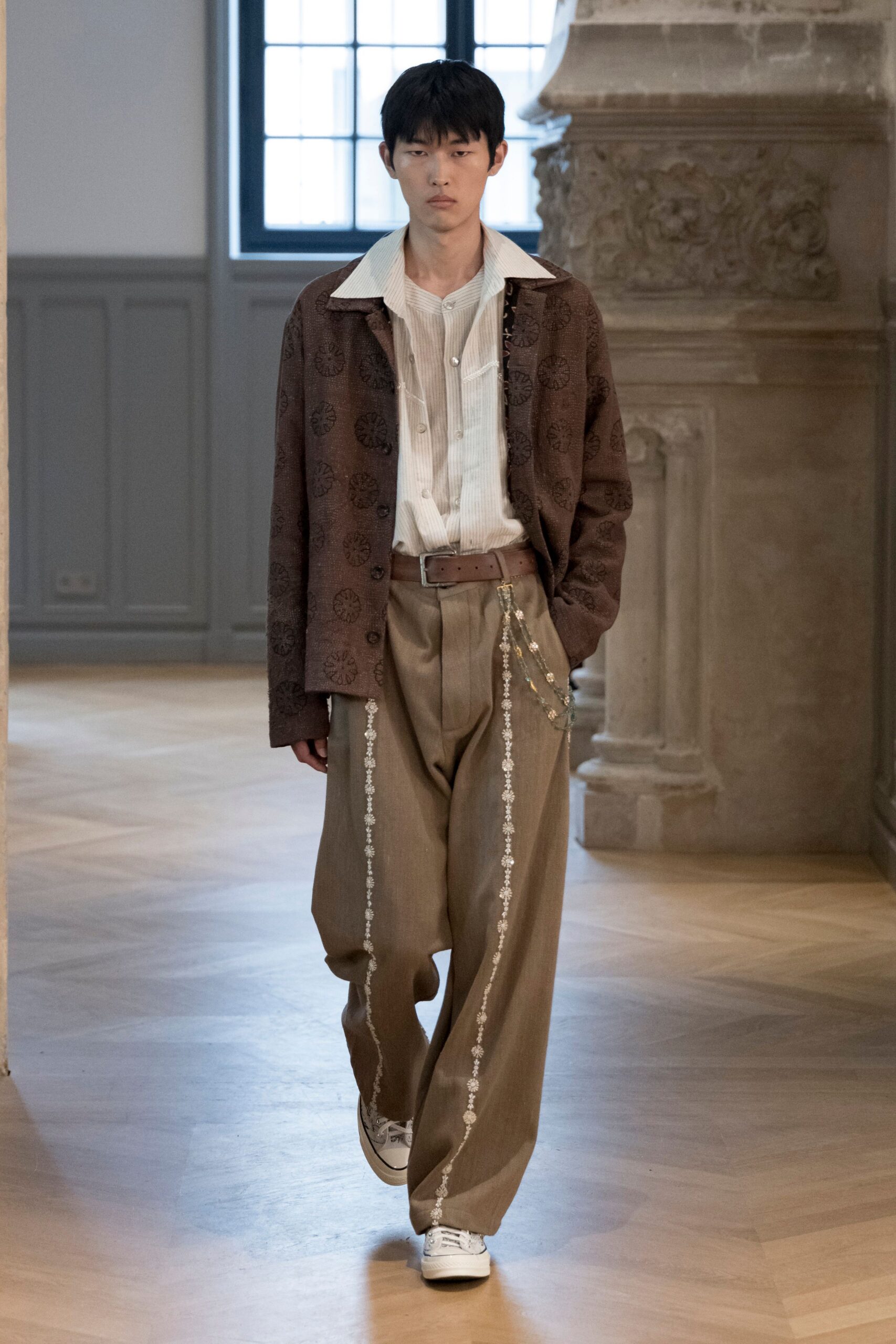 brown embroidered jacket with beige pants