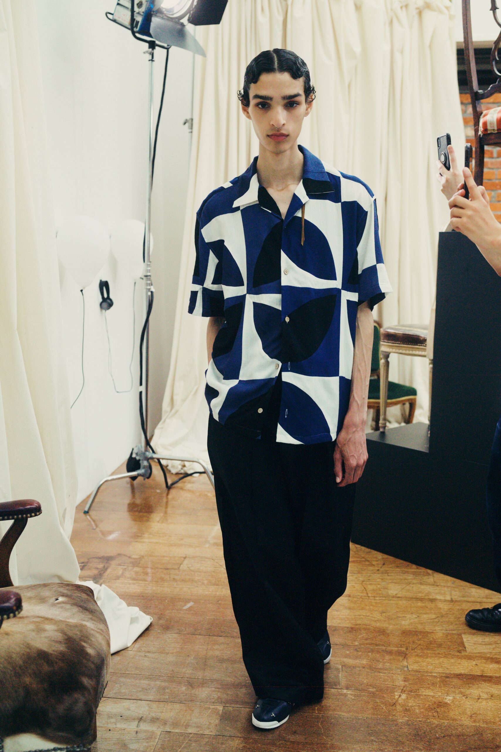 blue and white printed shirt with black pants