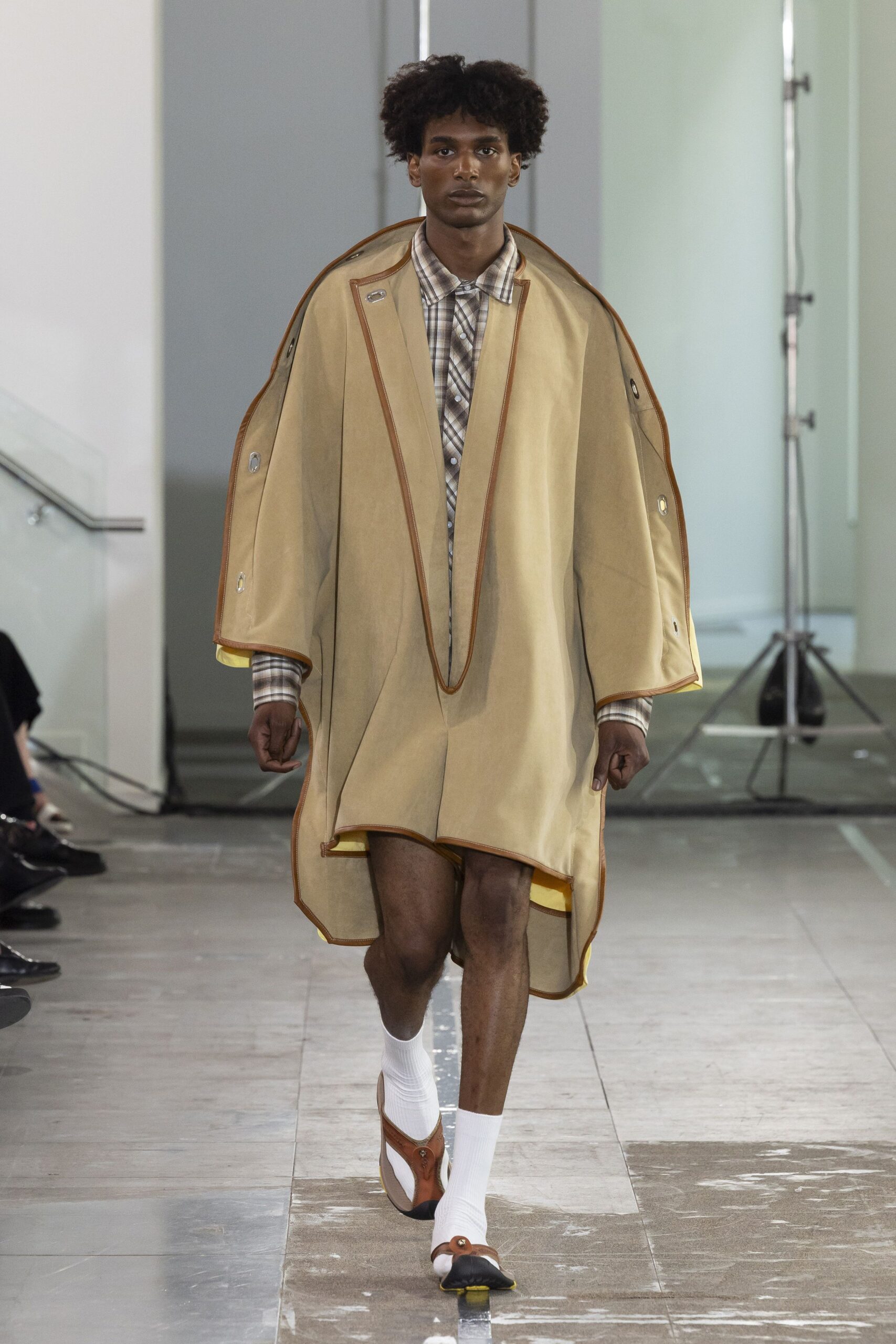 beige cape with checked shirt