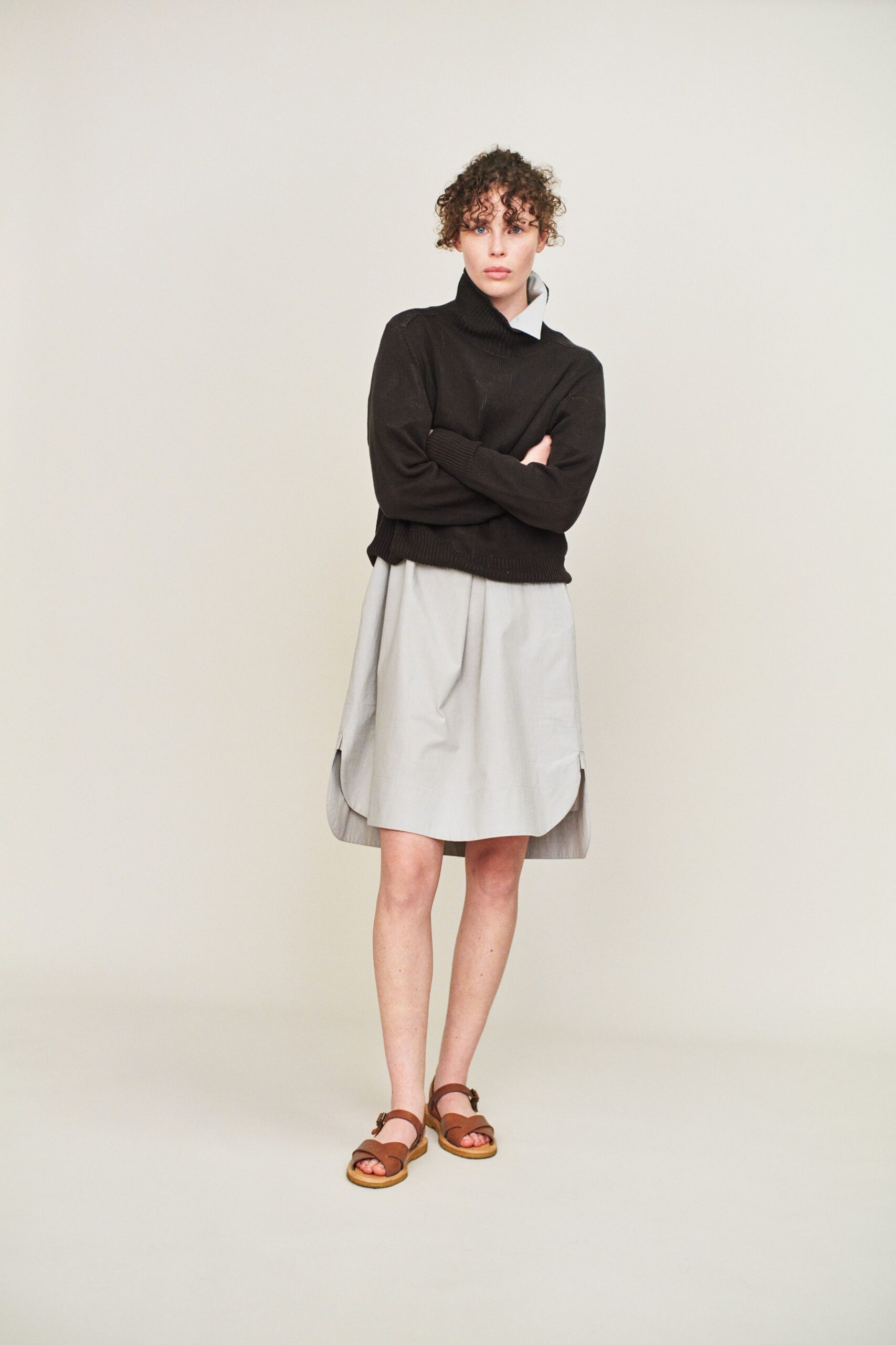 black sweater gray pleated skirt sandals