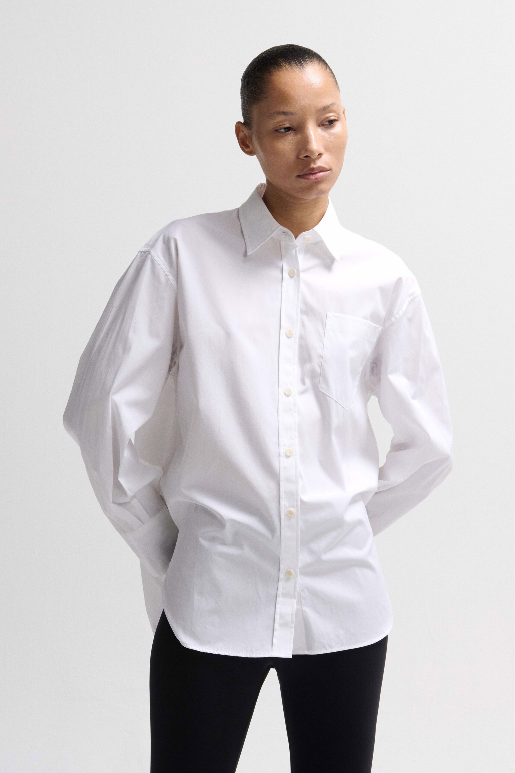 white relaxed shirt and black leggings