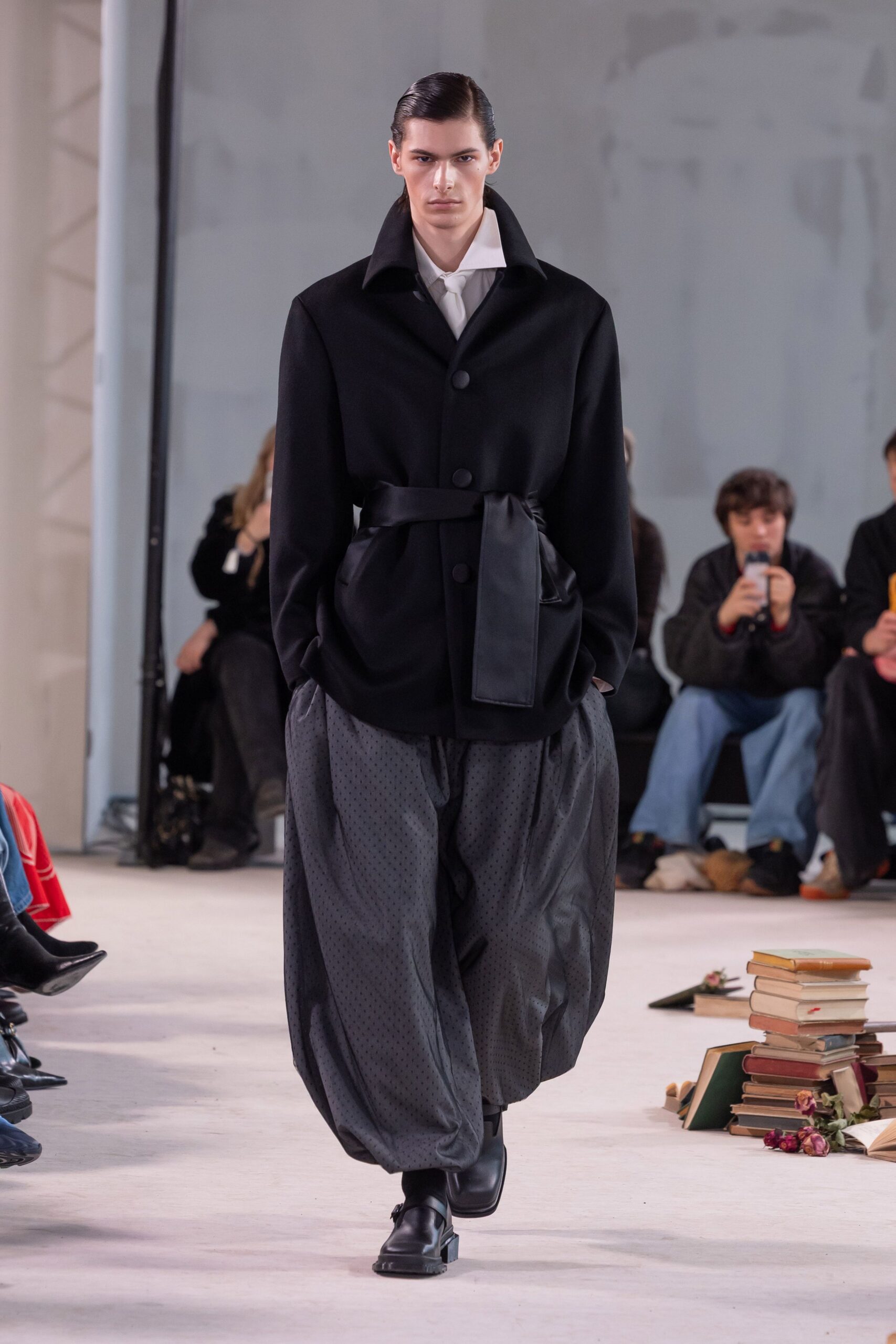 black wool coat and relaxed pants